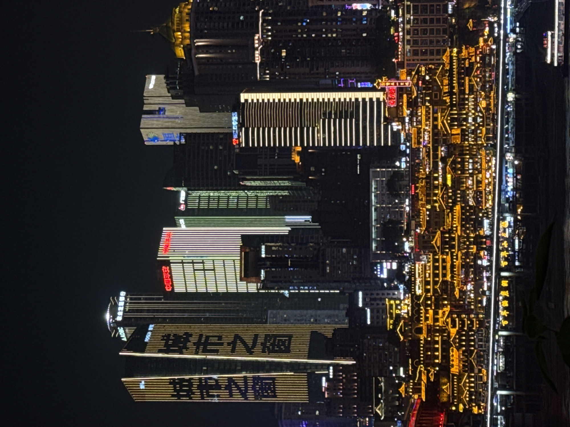 Chongqing's illuminated skyline and riverfront captured at night