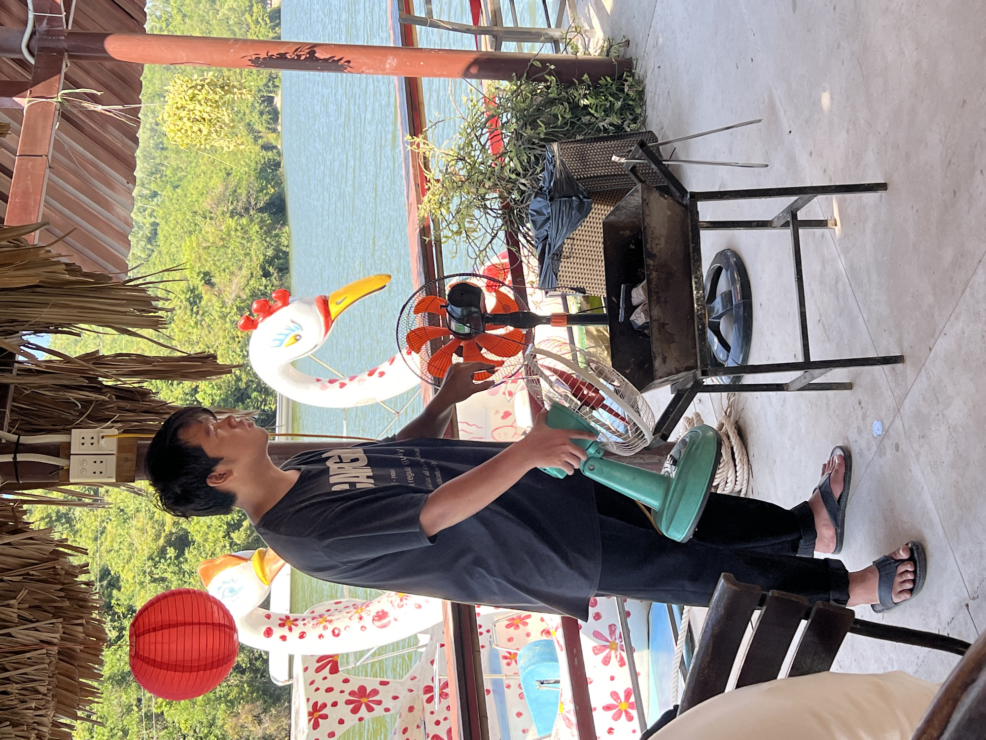 Waterfront barbecue dining scene with friendly dog in Nha Trang