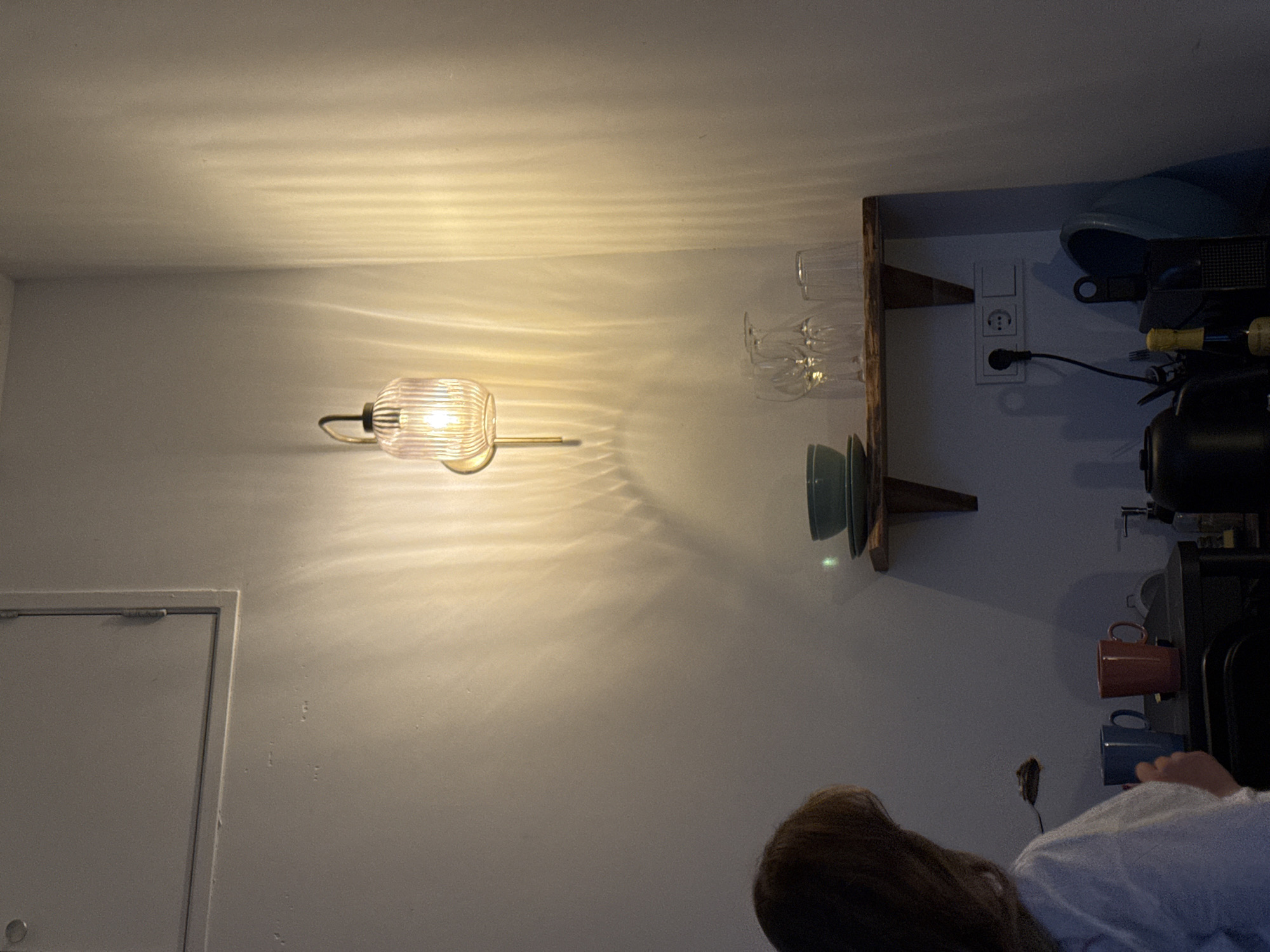Person examines wall shelf in Amsterdam residential interior