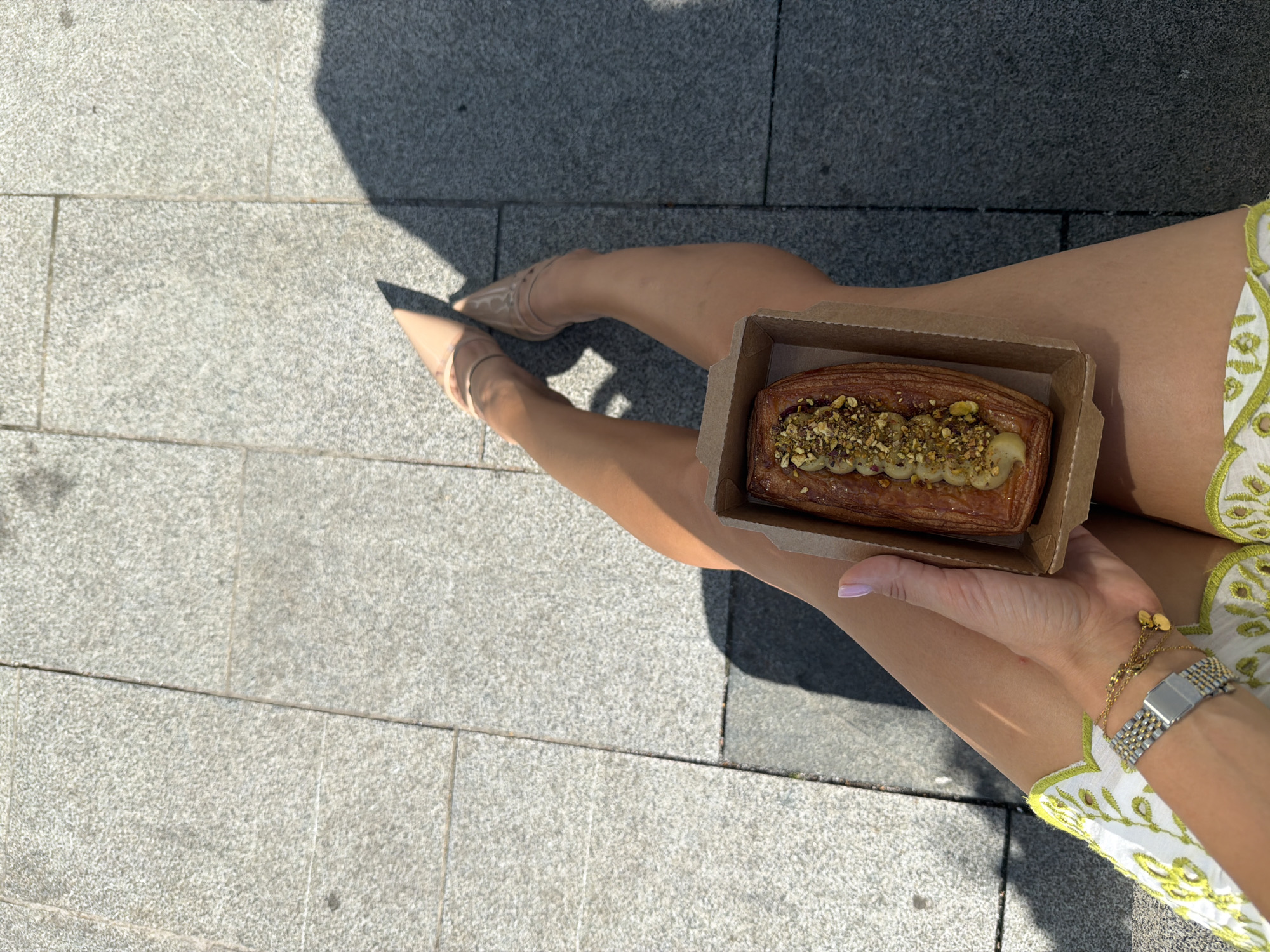 Pastry break on a sunny stone square in Batumi