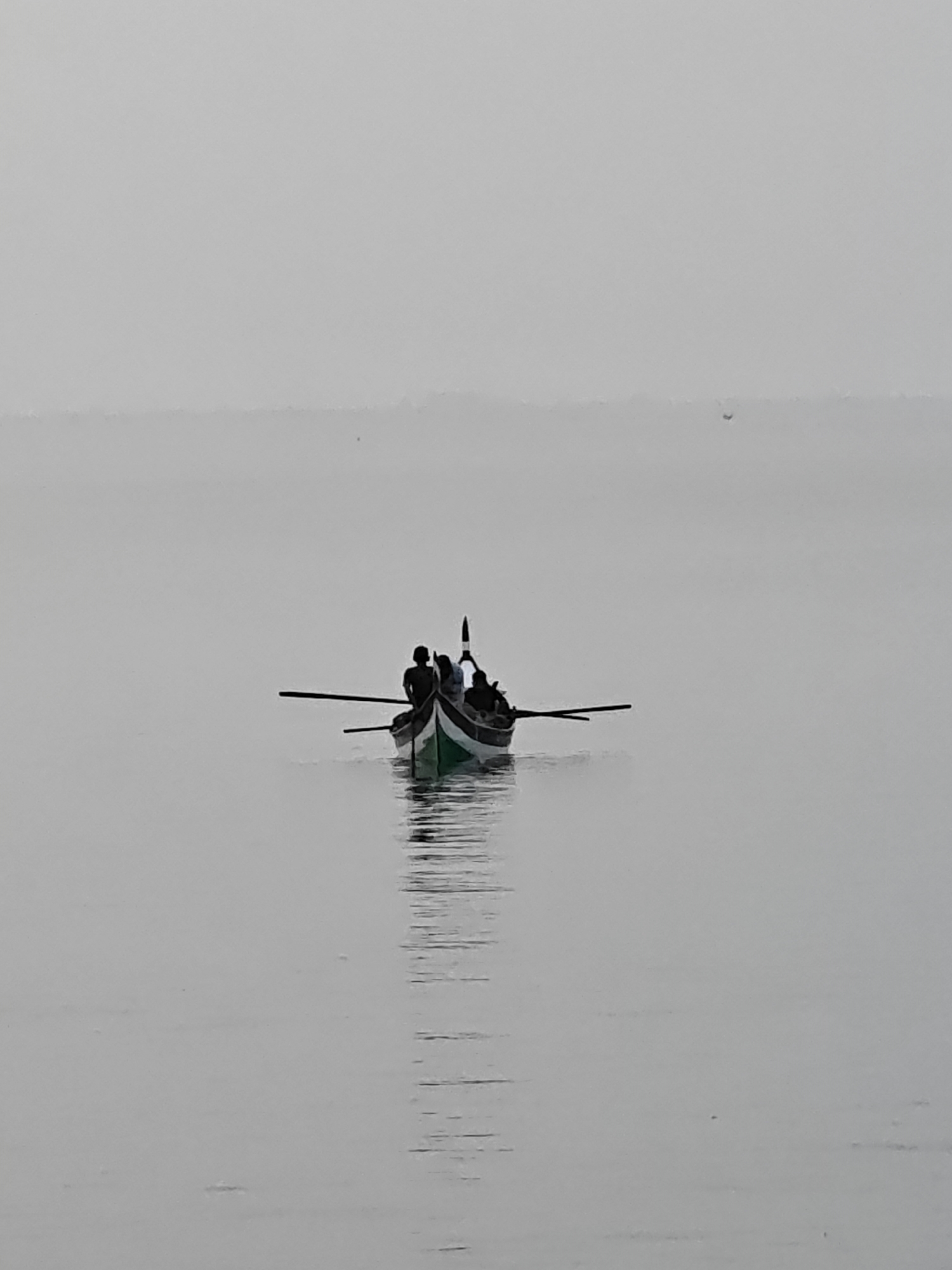 Traditional boats navigate calm waters near Lhokseumawe, Indonesia