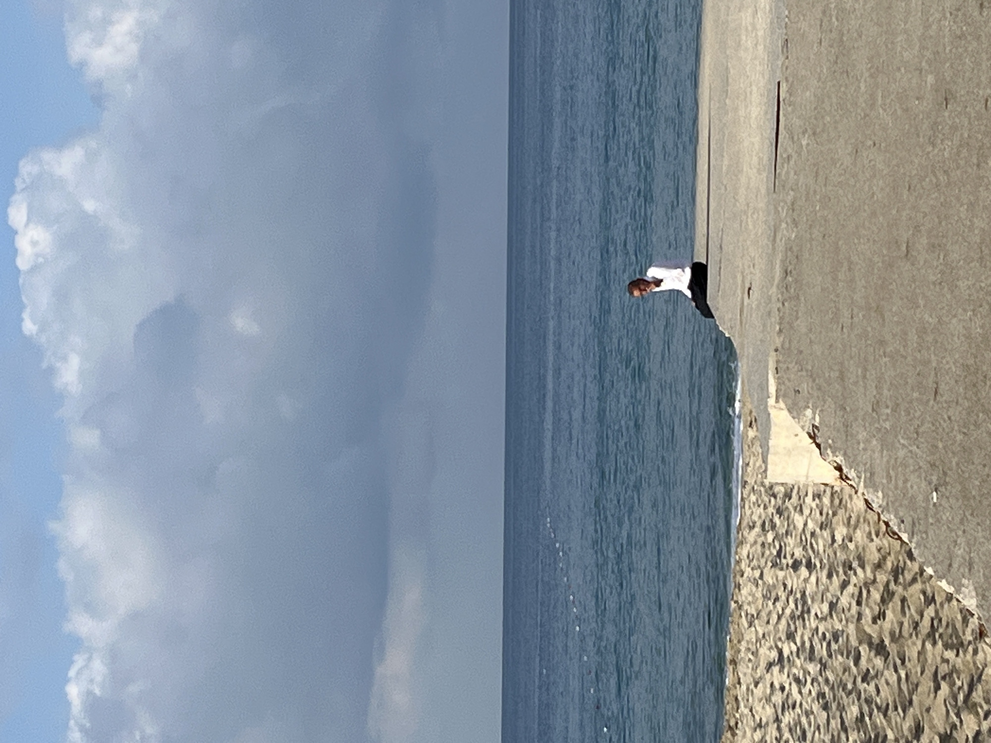 Man stands on seaside concrete structure in Alanya
