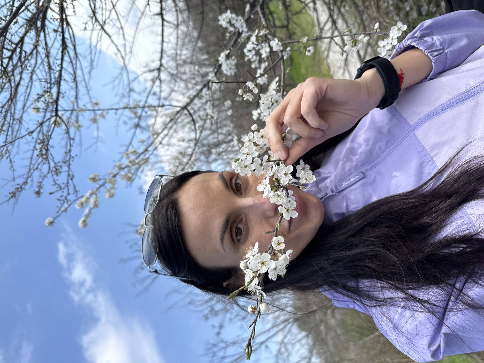 Woman poses with flowering branch in Pleven, Bulgaria