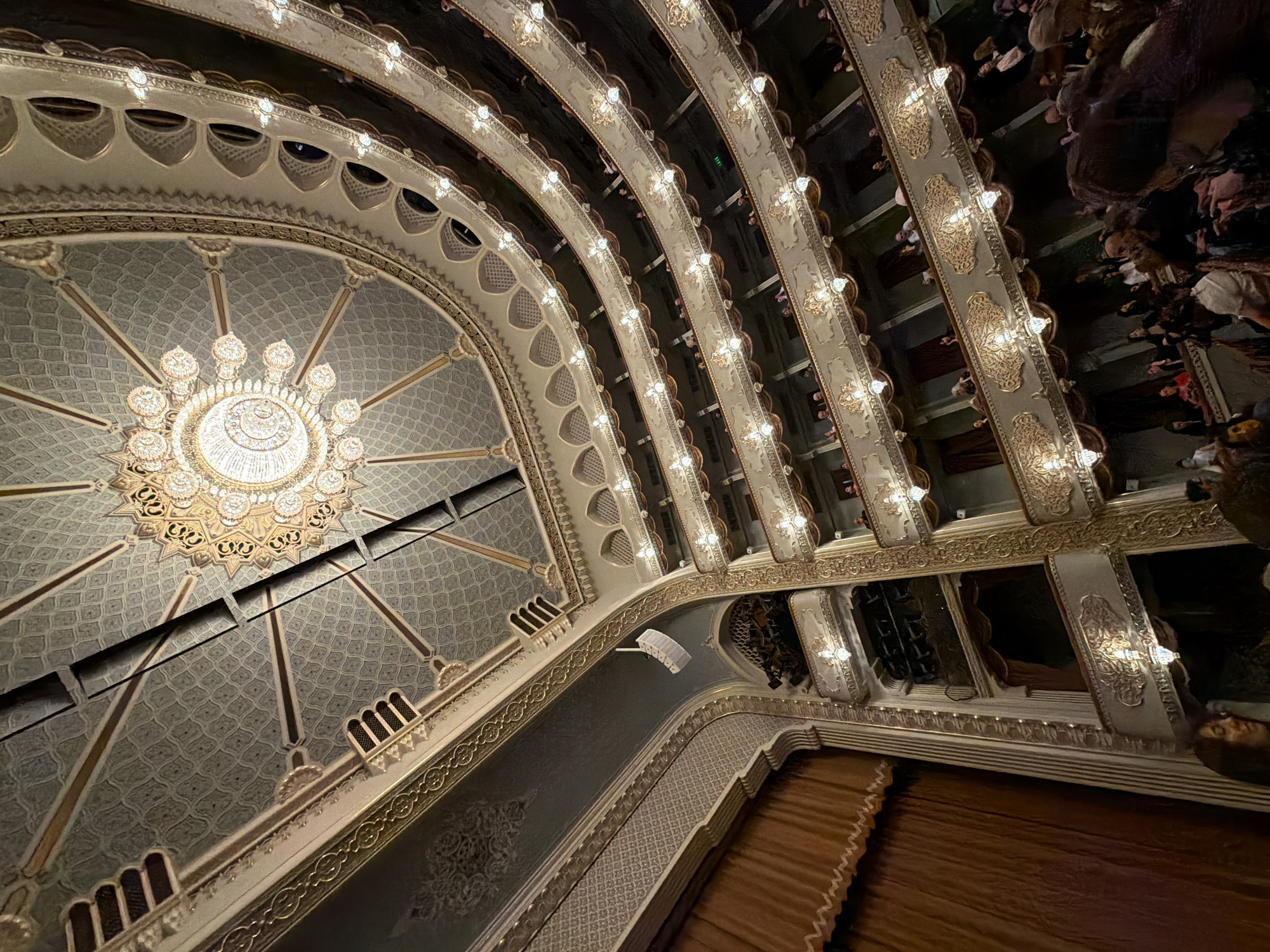 Visitor photographs ornate interior of Tbilisi Opera House
