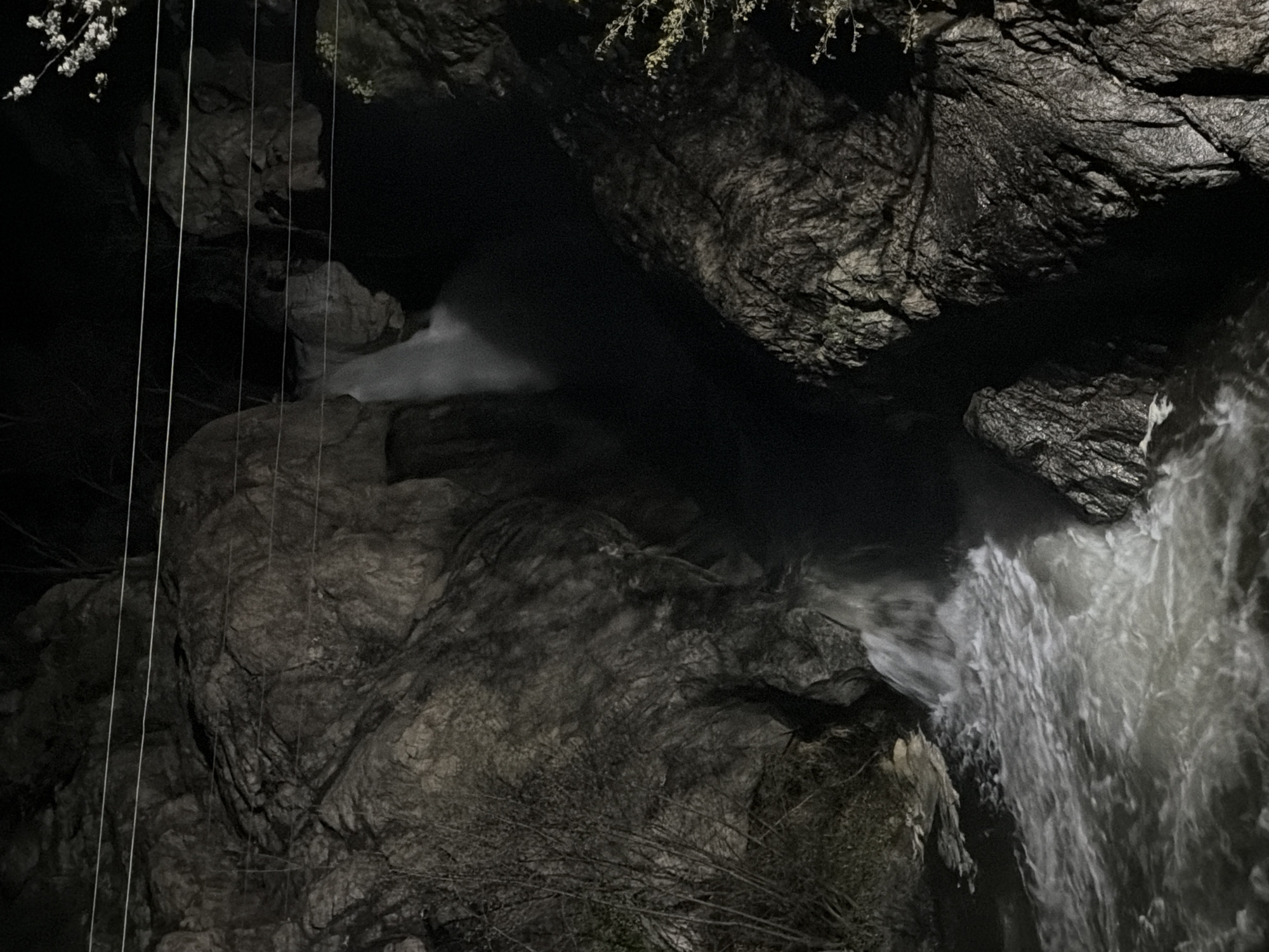 Nighttime waterfall observed cascading through rocky gorge in Karlovo