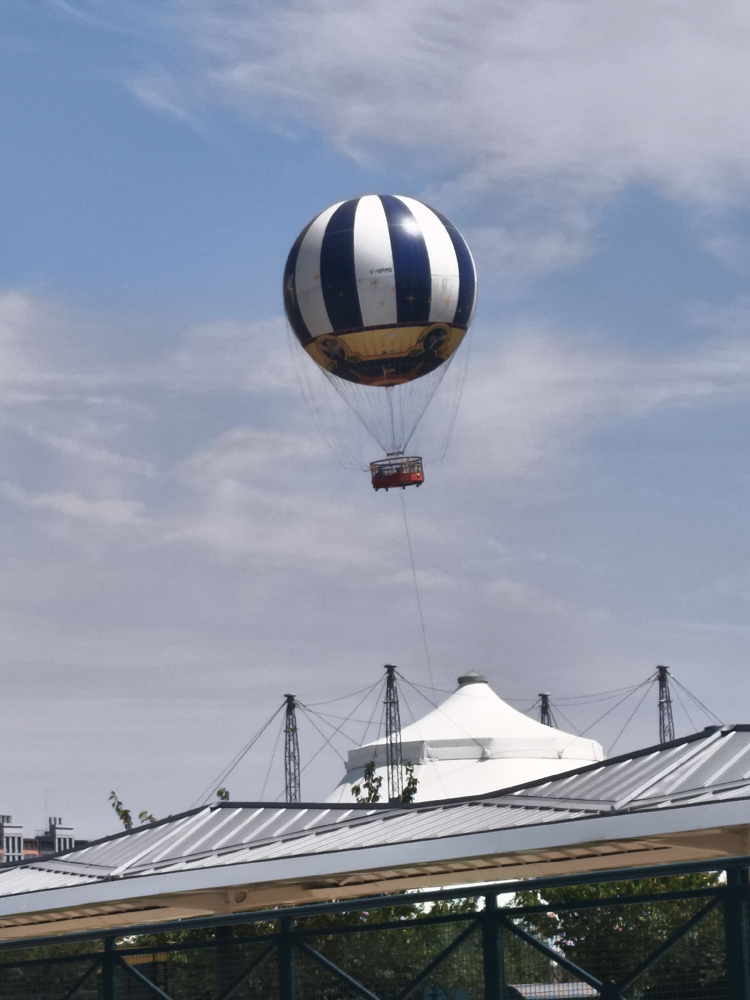 Hot air balloon drifts over Chessy skies on a cloudy morning
