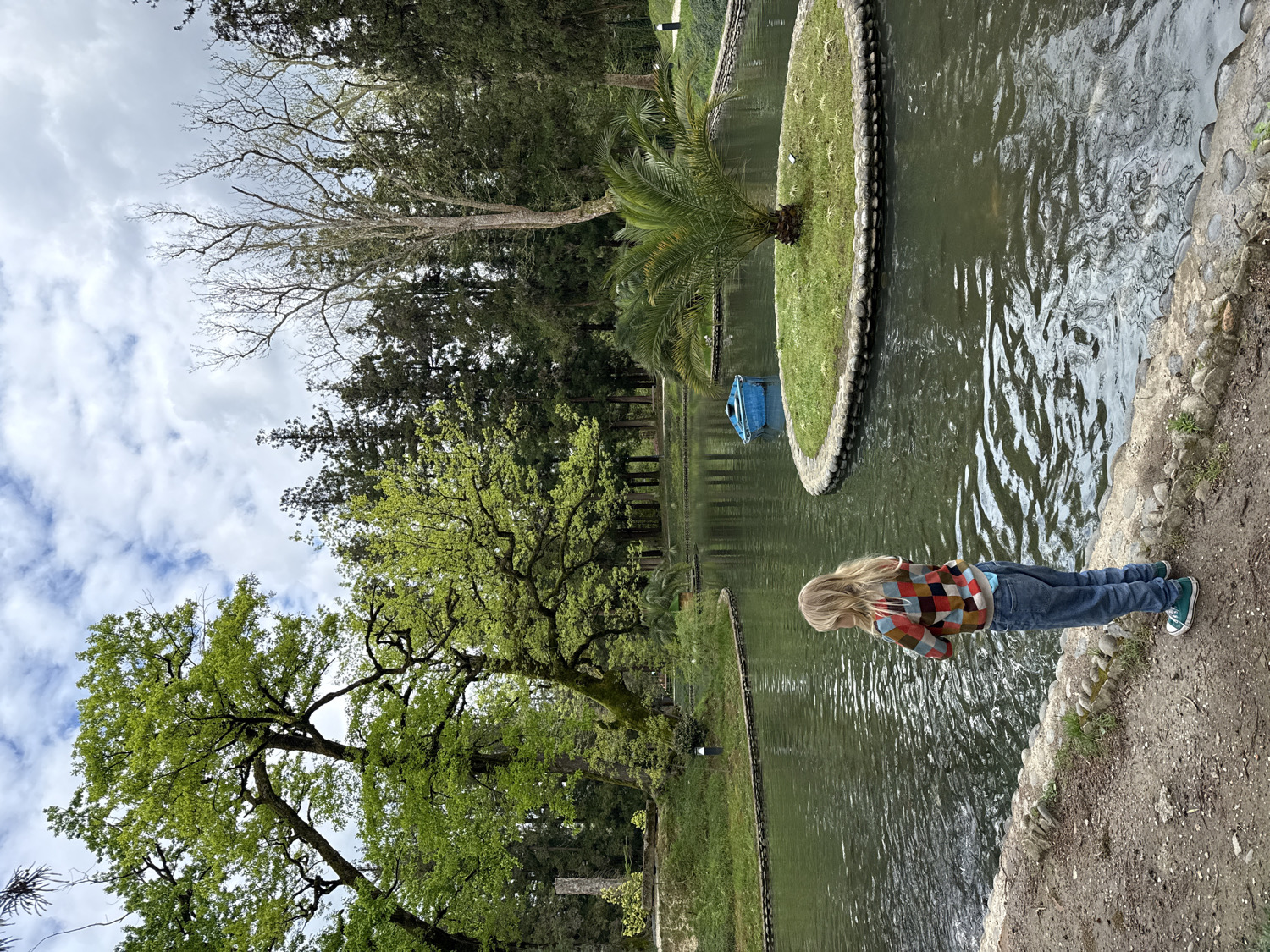 Child photographed among blooming azaleas in Zugdidi park