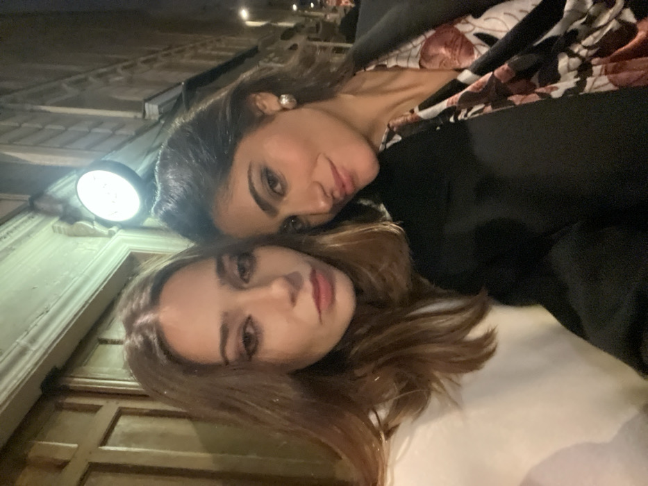 Two women enjoy evening dinner and drinks in Paris