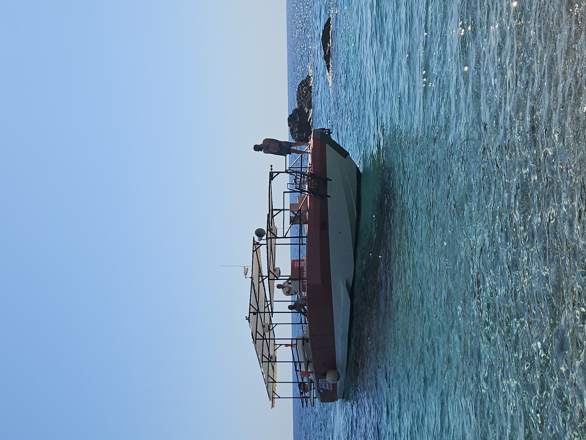 Lazy summer afternoon on the Montenegro coast by boat and beach