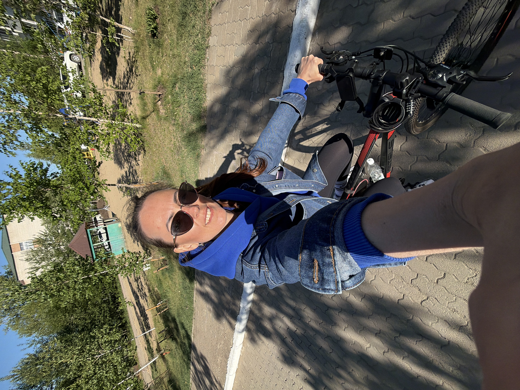 Woman cycles through Birobidzhan streets on spring morning