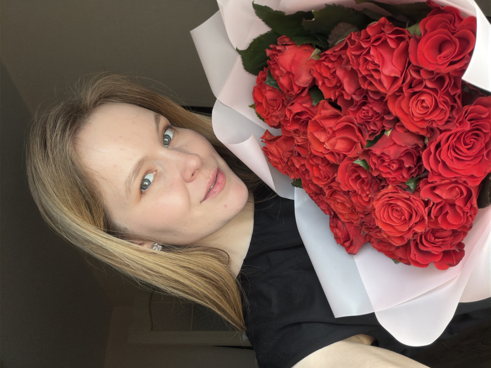 Woman displays red rose bouquet in Izhevsk, Russia