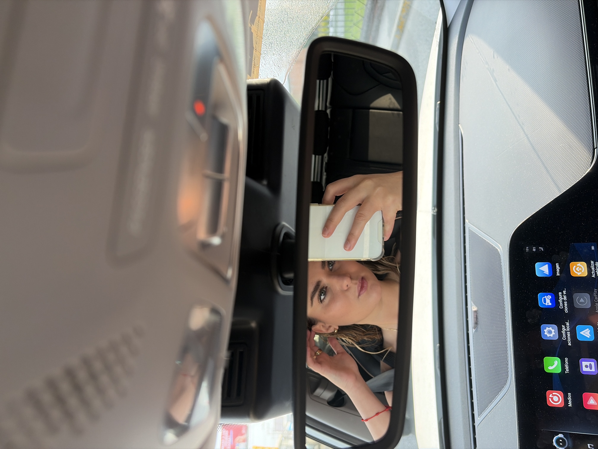Woman takes selfie in car rearview mirror in Mexico