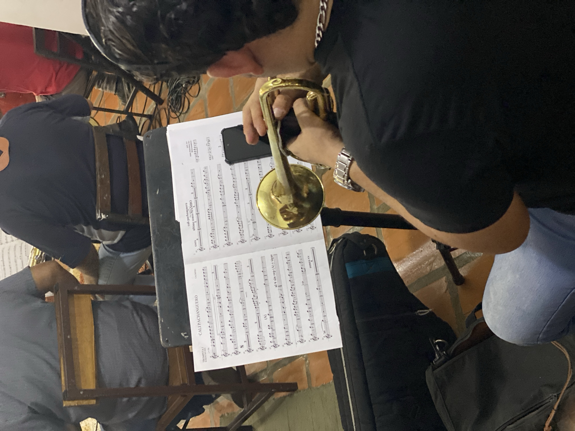Musicians rehearse brass instruments indoors in Tinaquillo, Venezuela