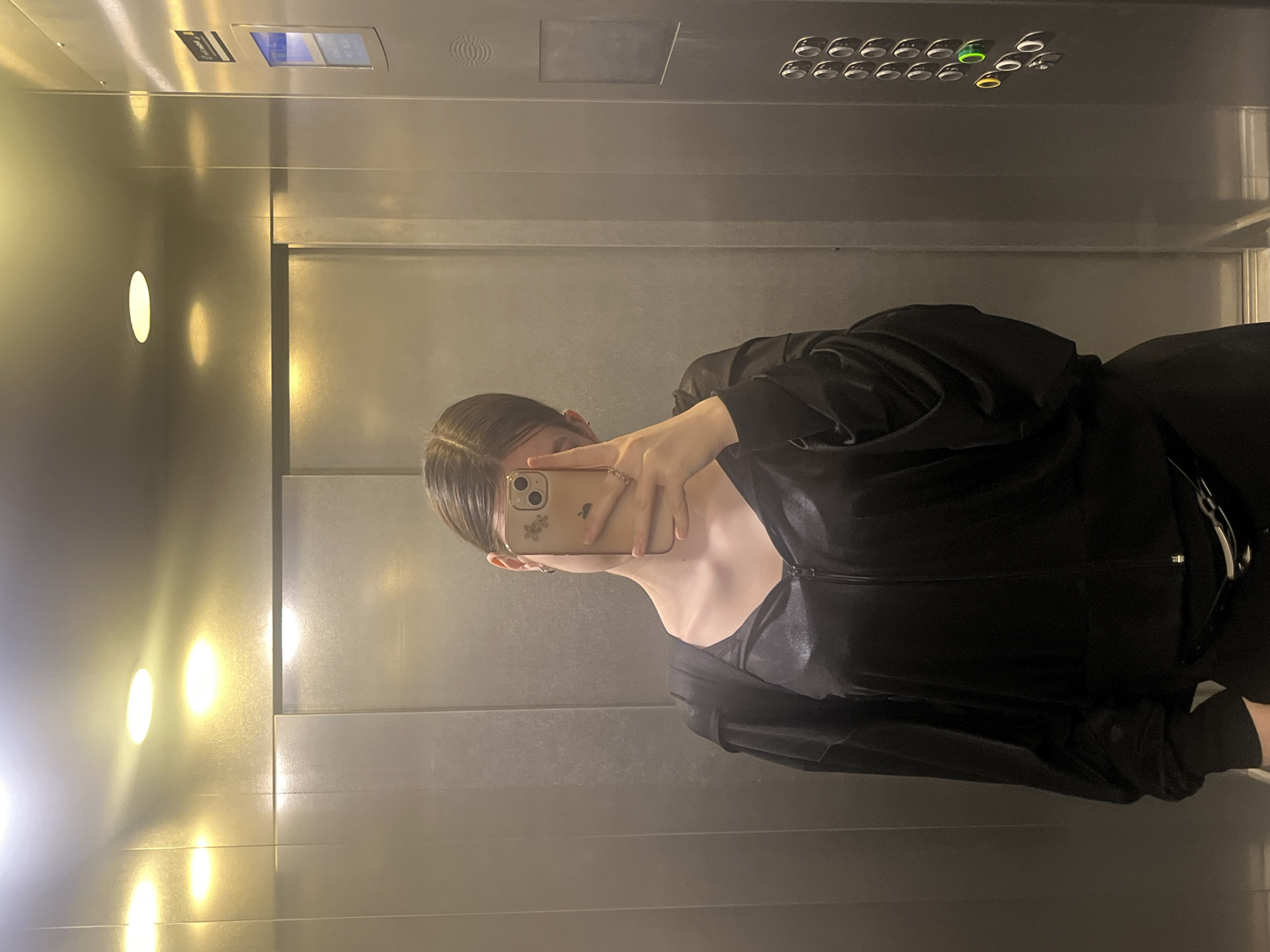 Person takes elevator mirror selfie in Russia