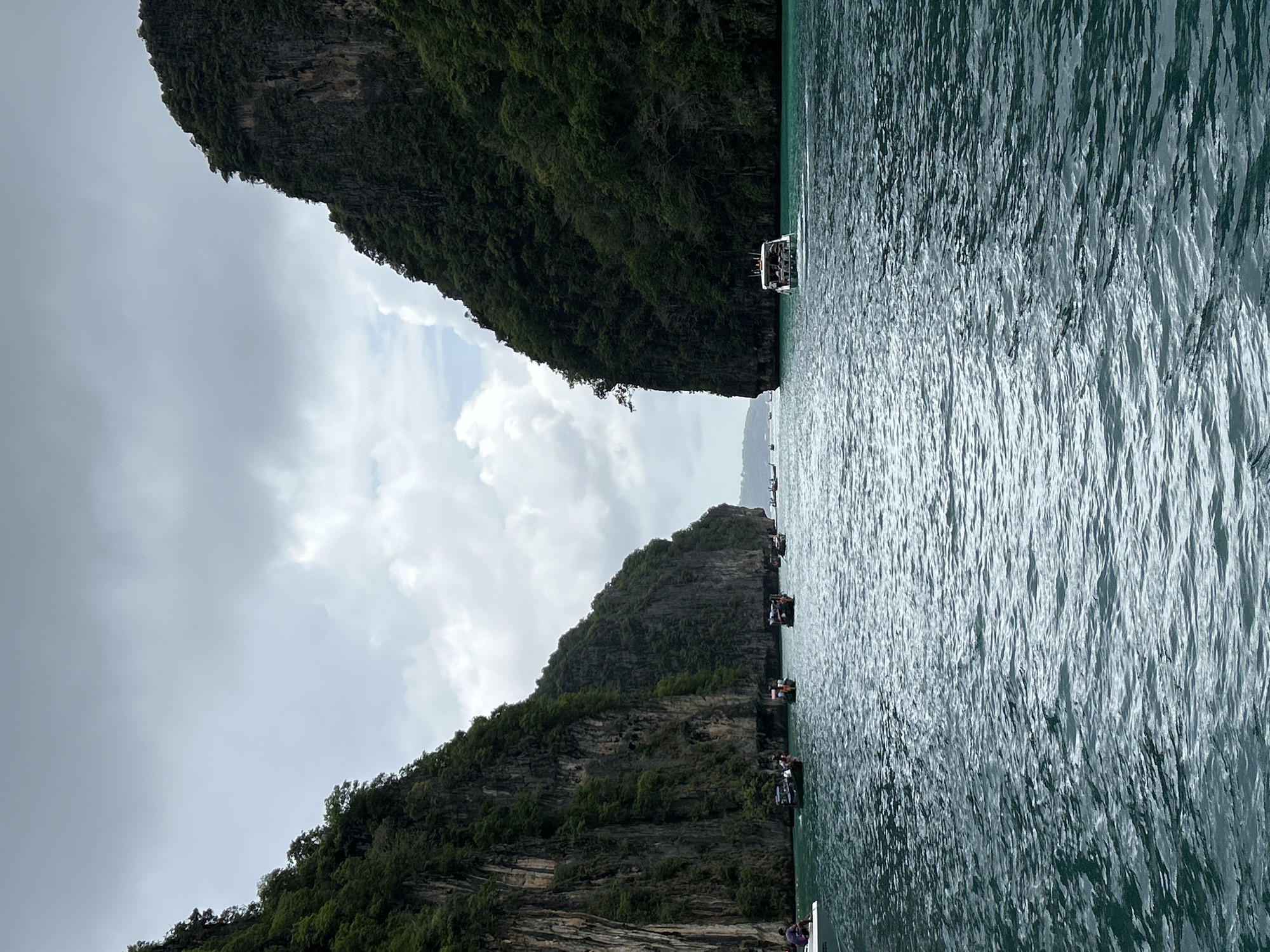 Tourists swim among limestone cliffs in Ao Nang waters