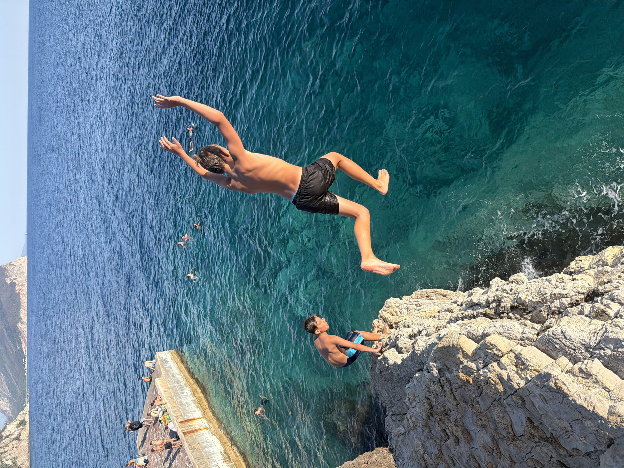 Cliff jumping into turquoise Adriatic waters at Petrovac