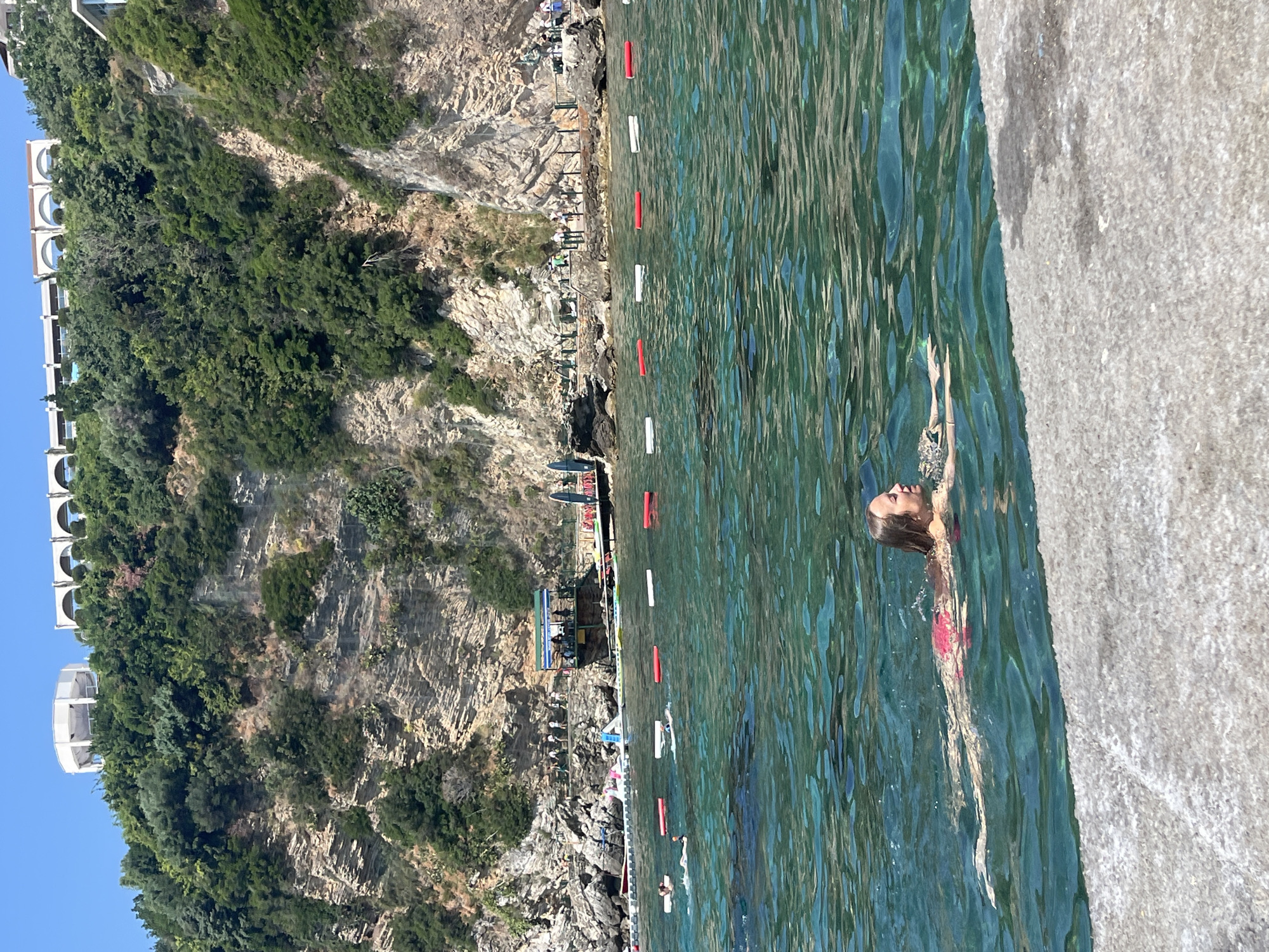 Sunny swim session off a Budva pier, Adriatic coast