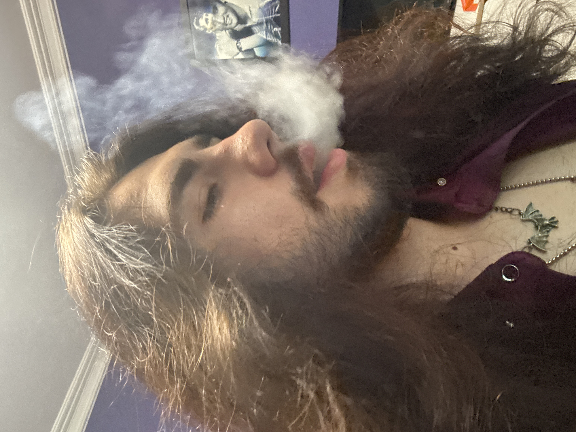 Self-portrait session: purple shirt, bat pendant, smoke