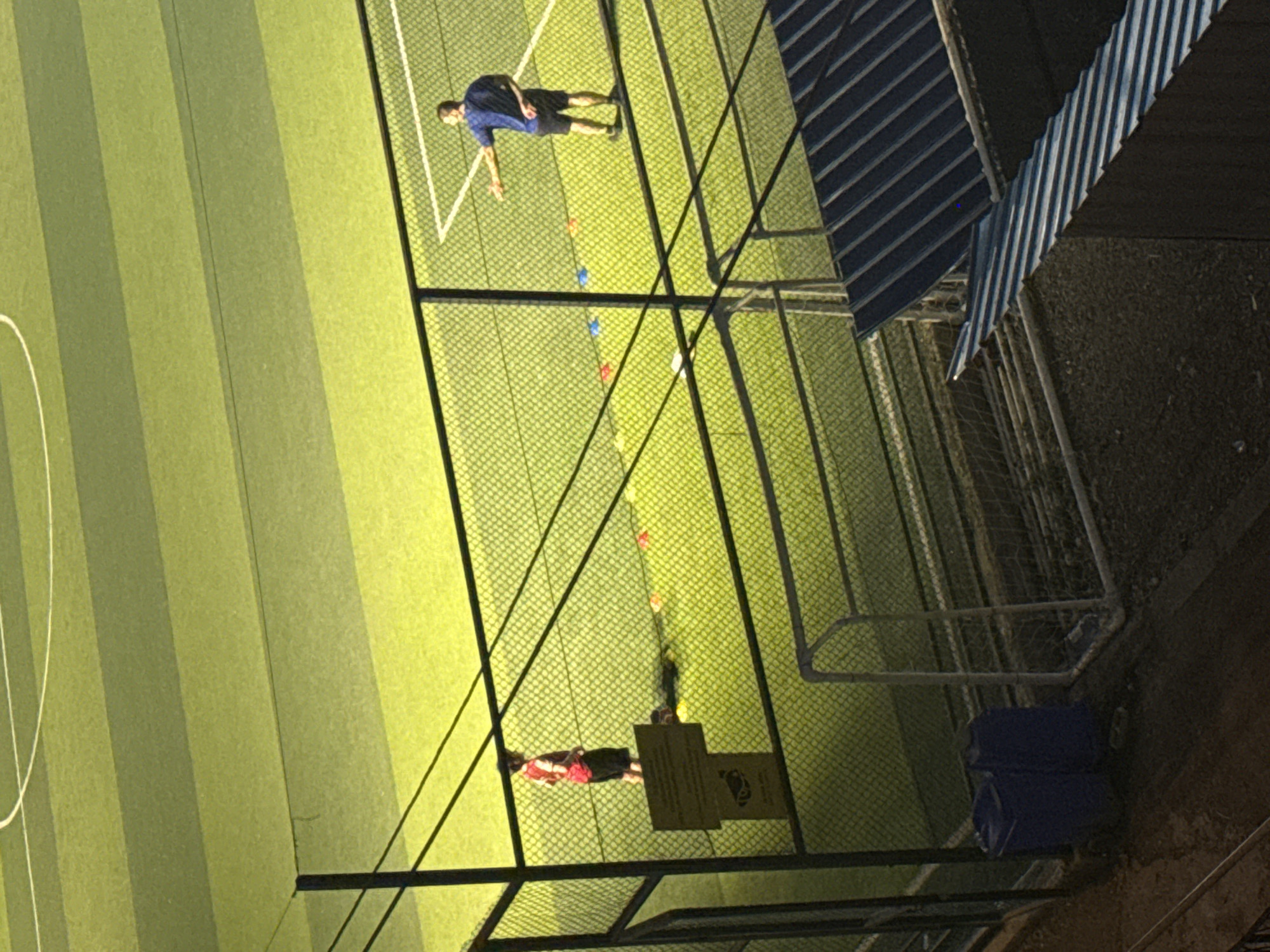 Soccer practice at dusk on a Tbilisi turf field