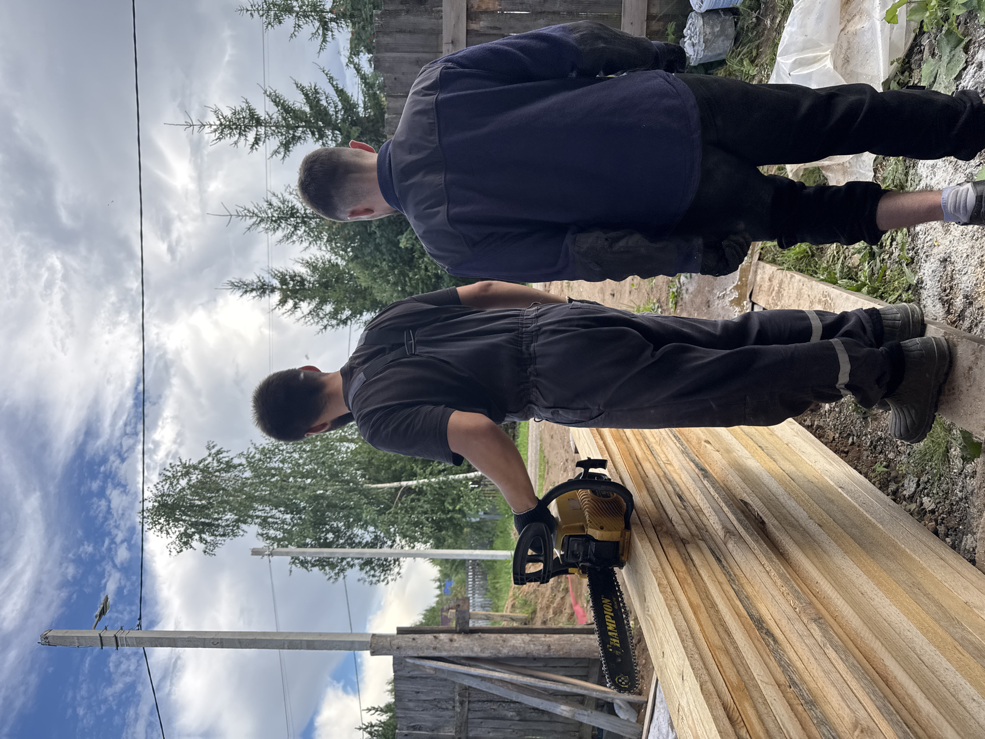 Chainsaw work on a lumber stack at a Perm construction site