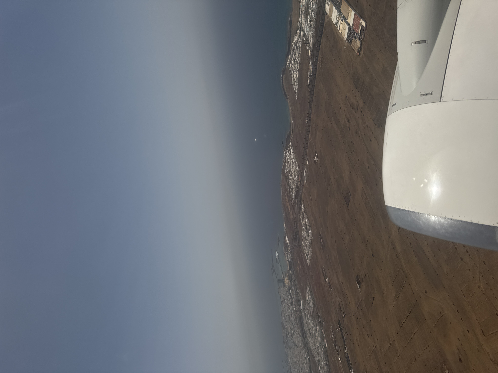 Aerial view captures San Bartolomé coastline from aircraft window