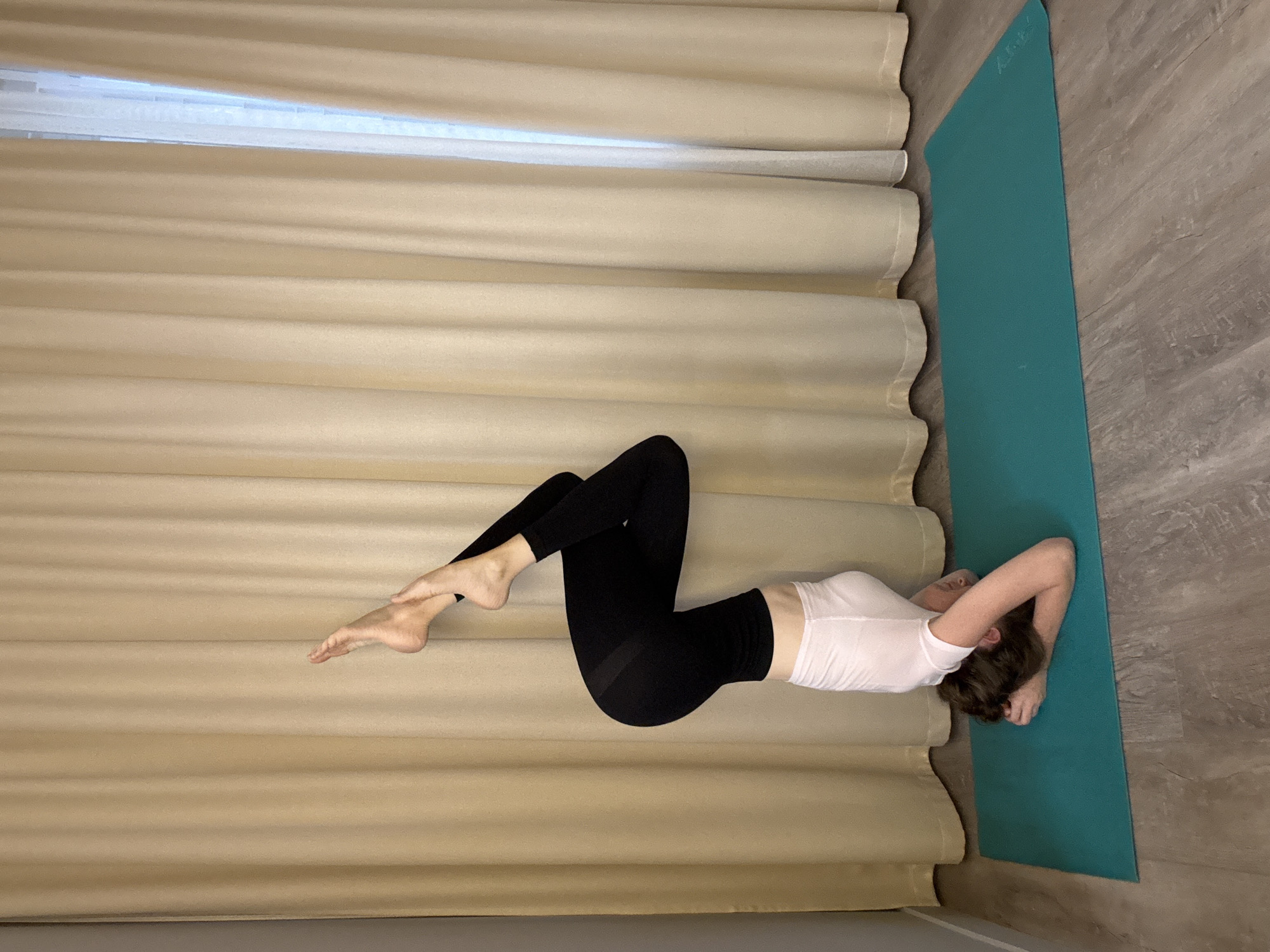 Yoga headstand sequence on a teal mat in Dolgoprudny