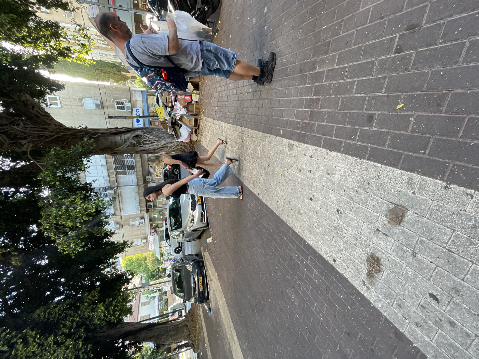 Afternoon street activity along a Kfar Saba commercial stretch