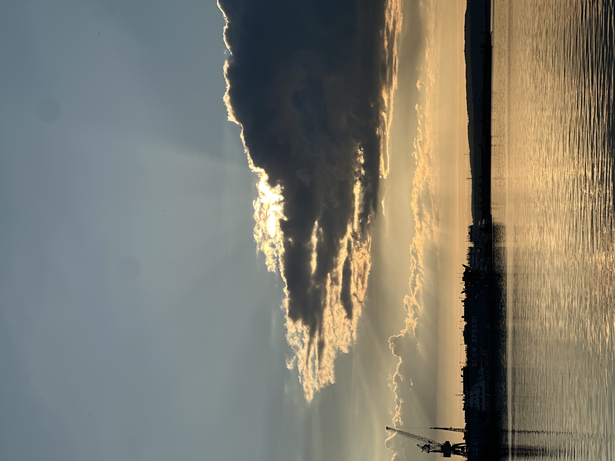 Golden hour at an industrial waterfront, sunset views all around