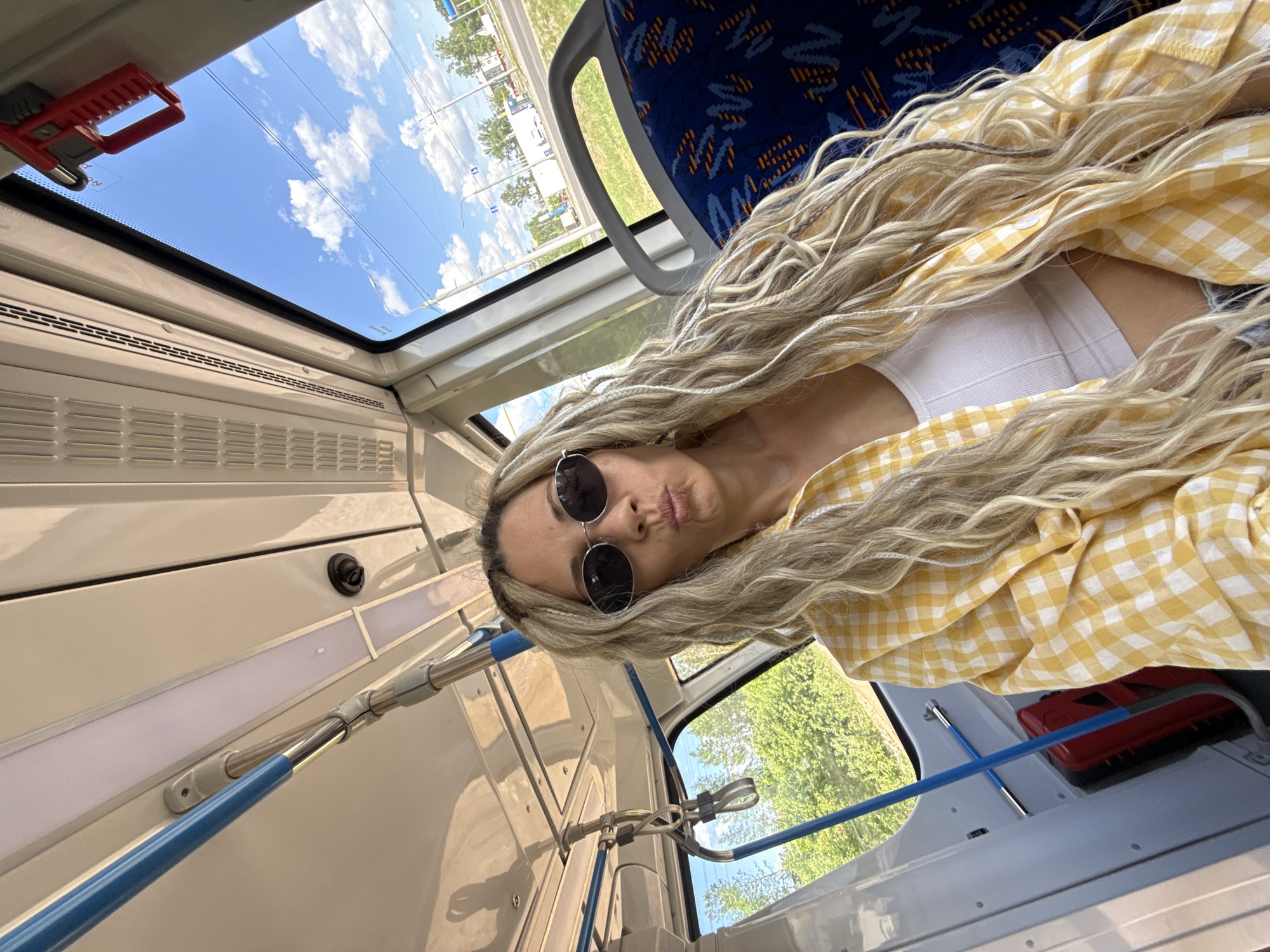 Woman in checkered shirt documented across Russian countryside morning