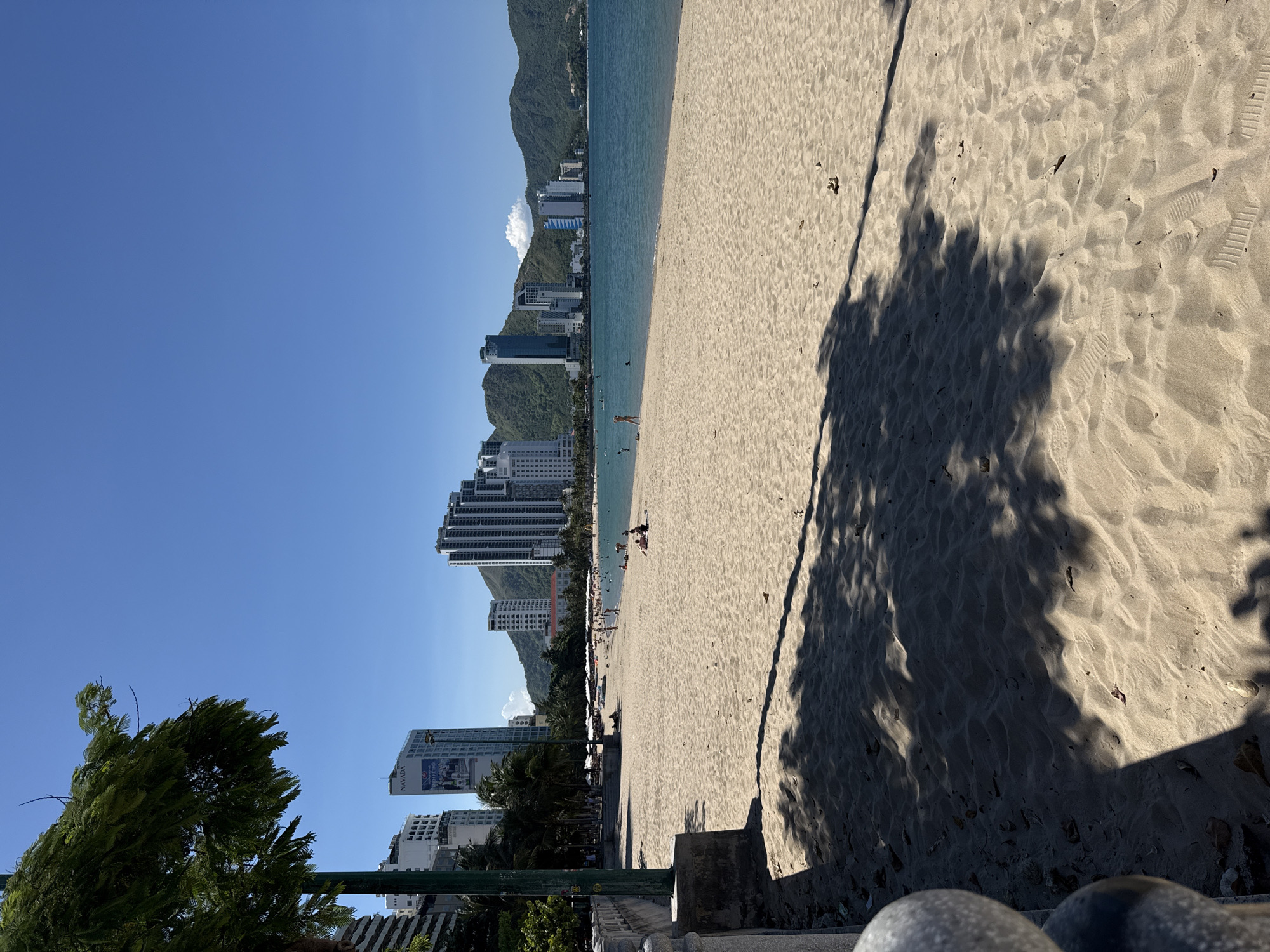 Morning on Nha Trang beach, skyline backdrop, quiet shoreline.