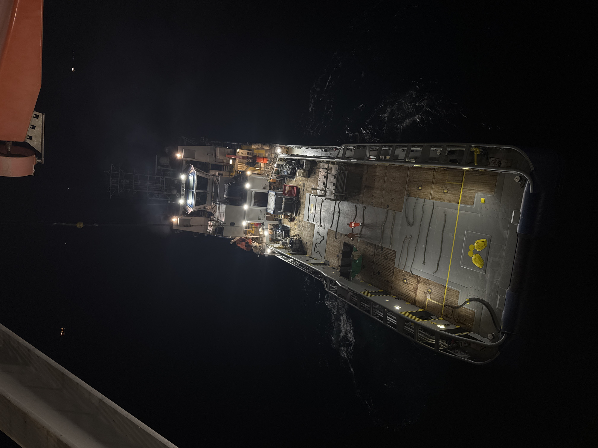 Nighttime crane transfer operation on offshore vessel IEVOLA BLUE