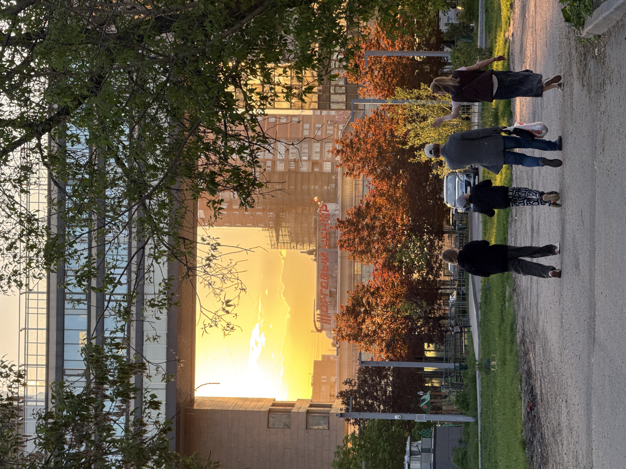 Evening pedestrians and spring blooms captured in Moscow sunset