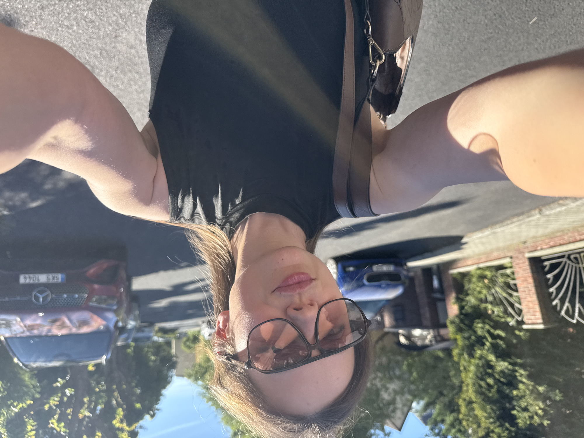 Woman takes selfies on sunny Karlovy Vary street