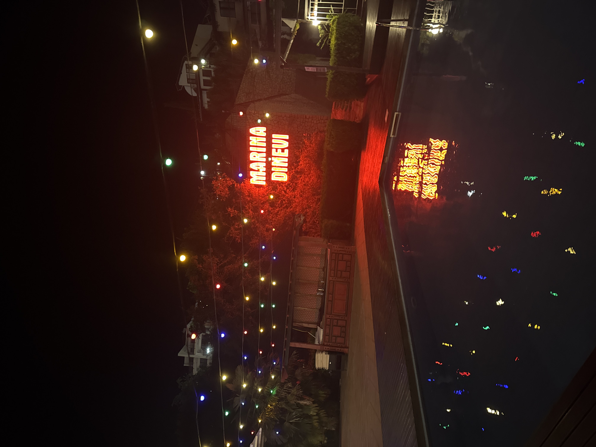 Marina Dinevi at night, neon lights and a vintage Lincoln