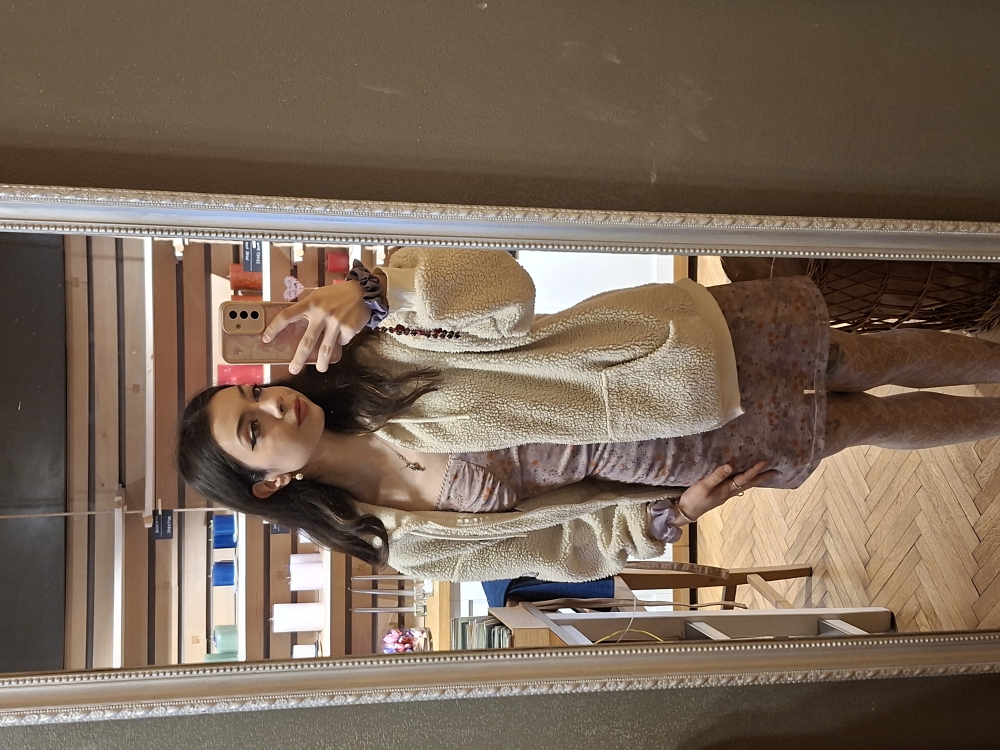 Woman takes mirror selfie in floral dress in Sofia