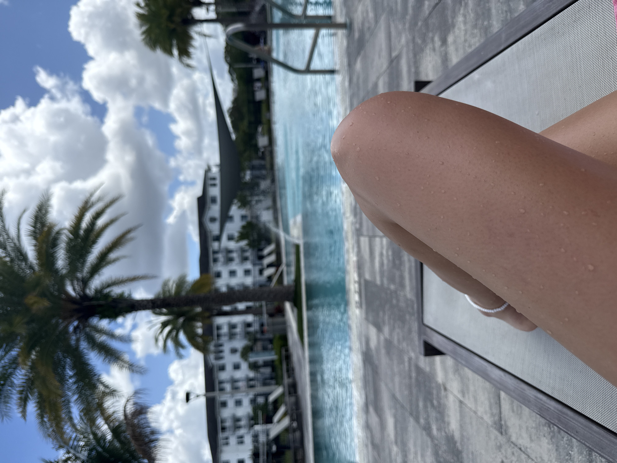 Person relaxes poolside in Naples, Florida