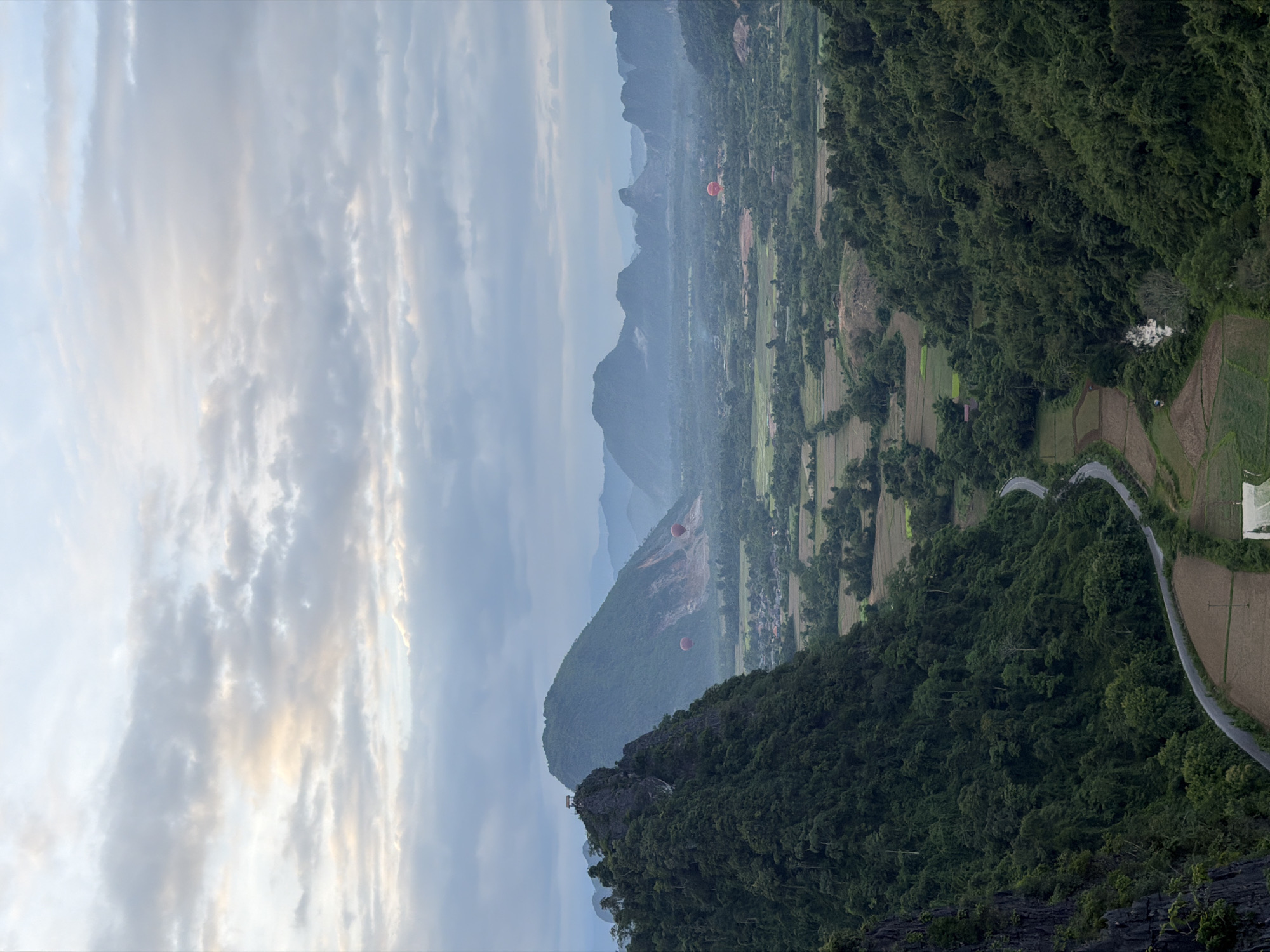 Sunset and hot air balloons over Naka's karst mountains