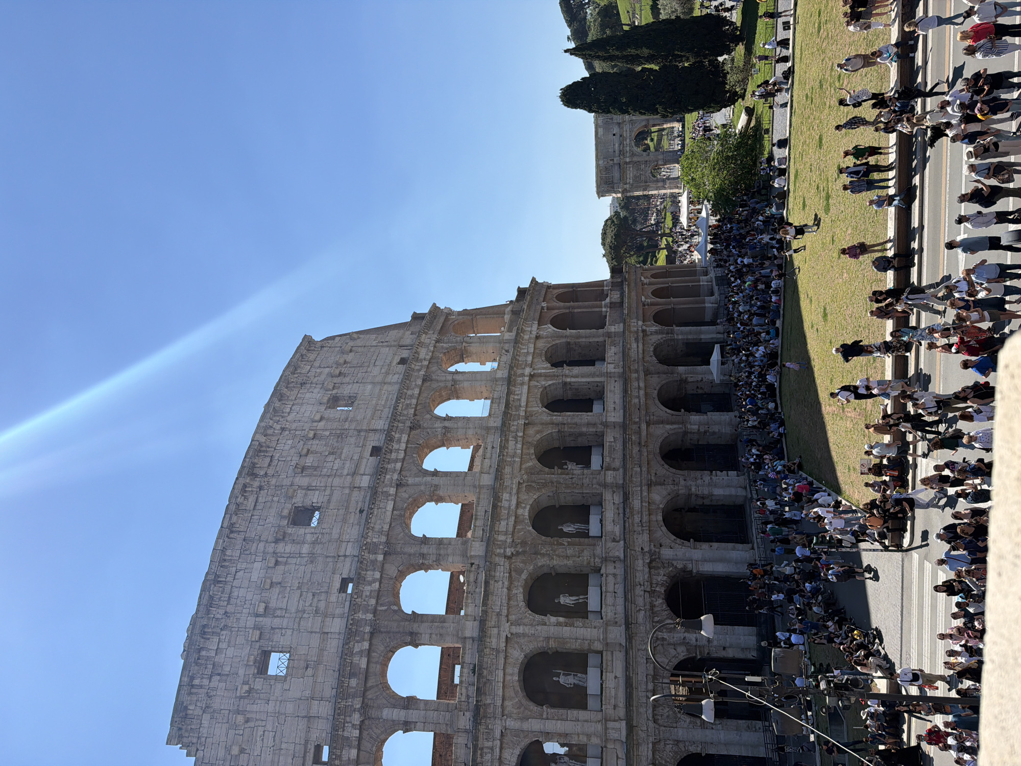 Crowds gather at Rome's Colosseum under clear skies