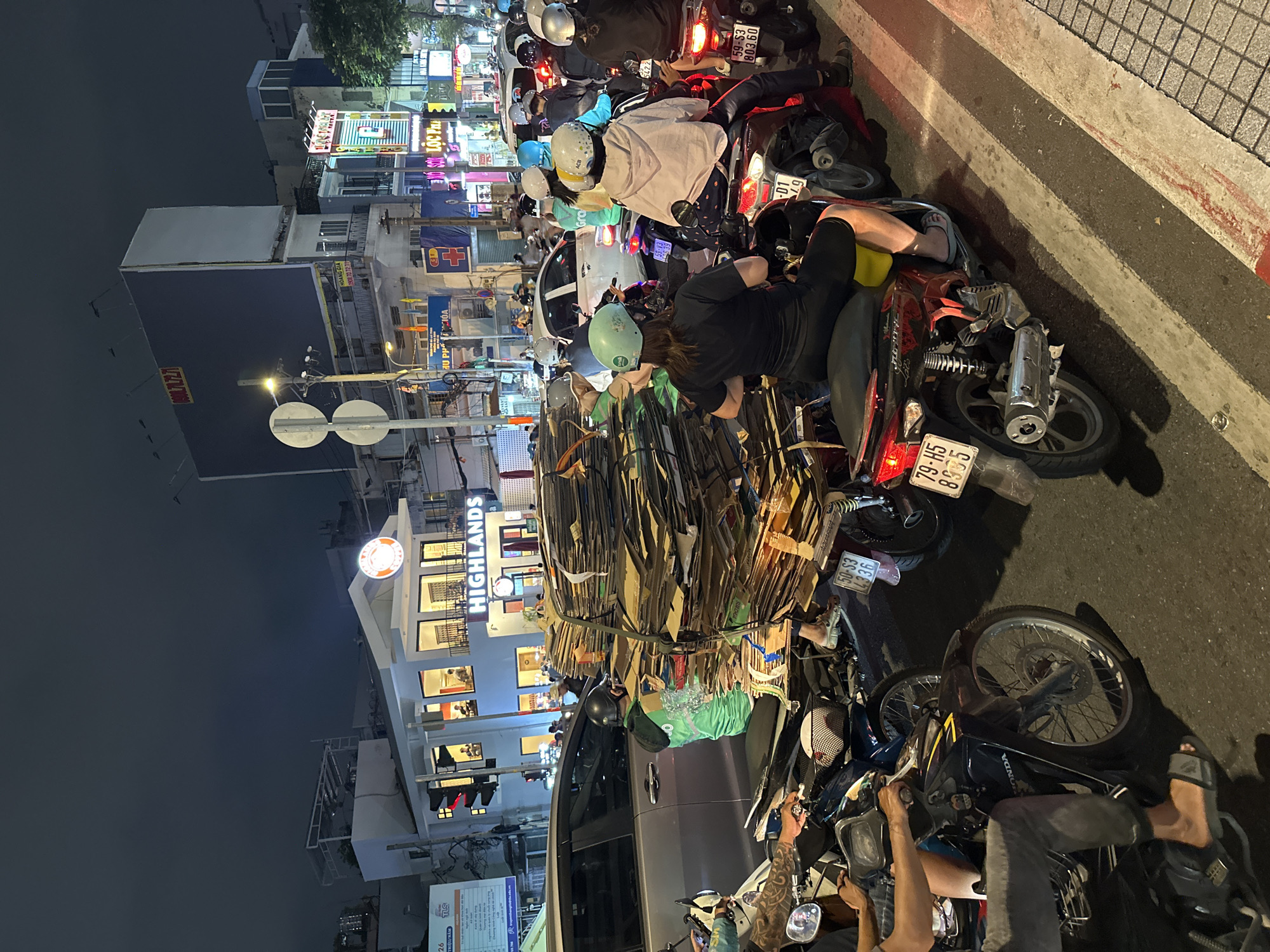 Dense motorbike traffic flows through Thủ Đức streets at night