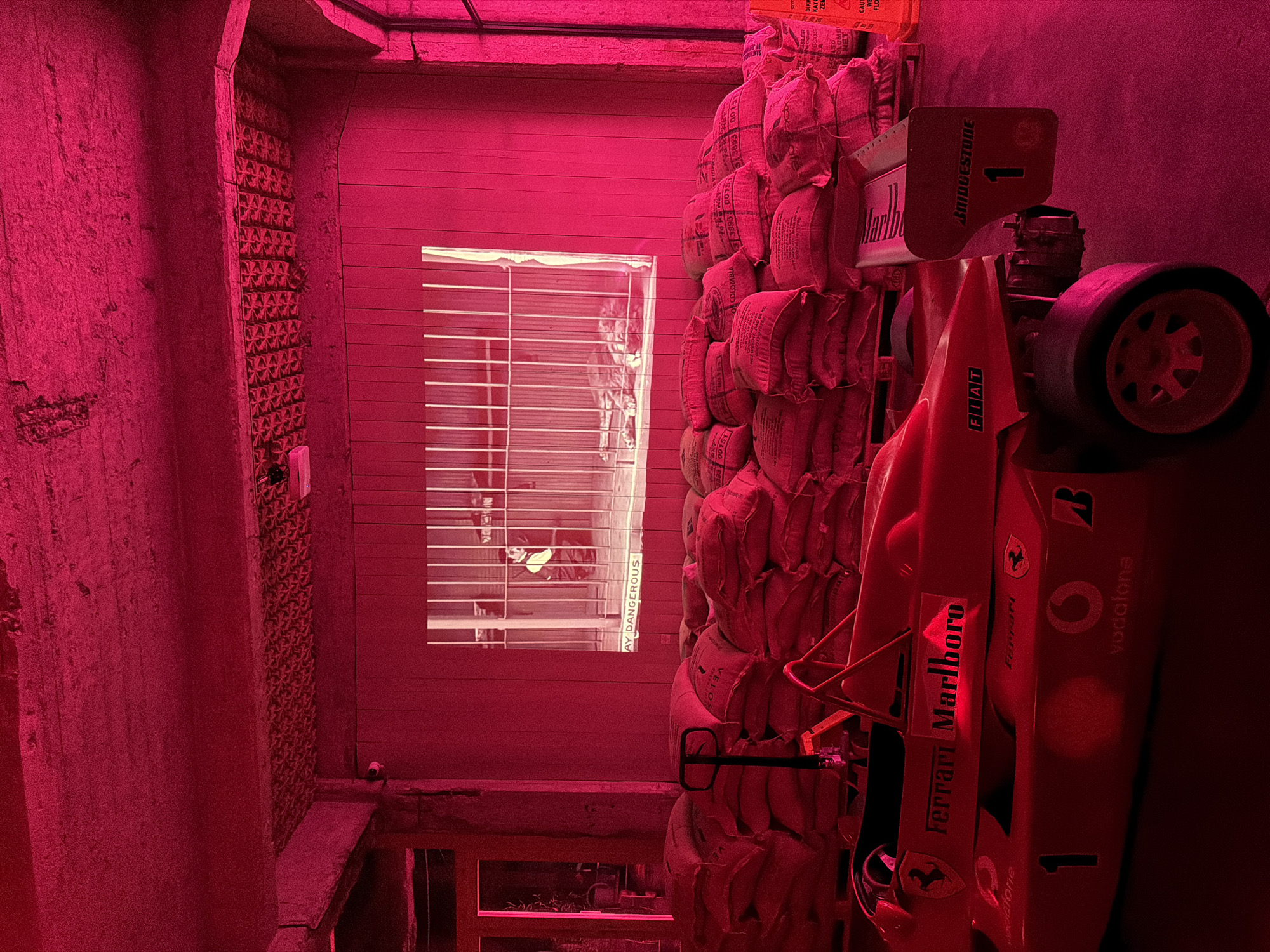 Burlap sacks stored under red lighting documented in Tbilisi