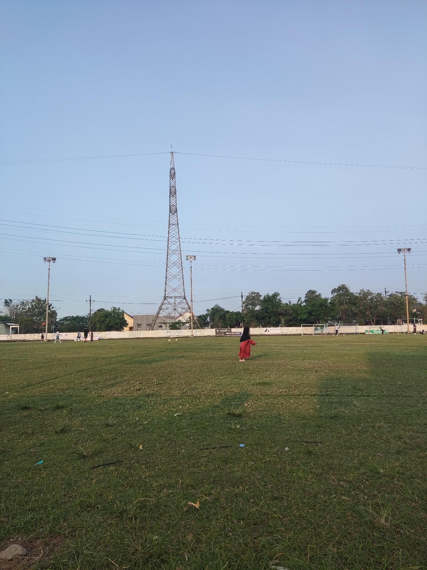 Soccer practice on a Sidokepung grass field on a July morning