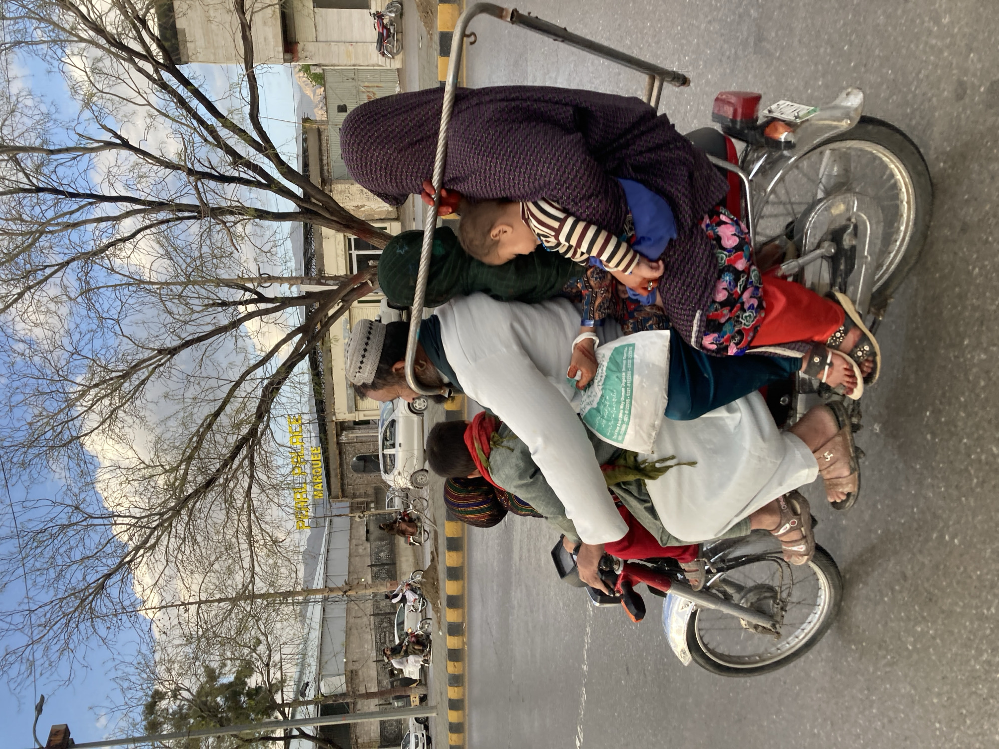 Overloaded motorcycle carries five people in Quetta, Pakistan