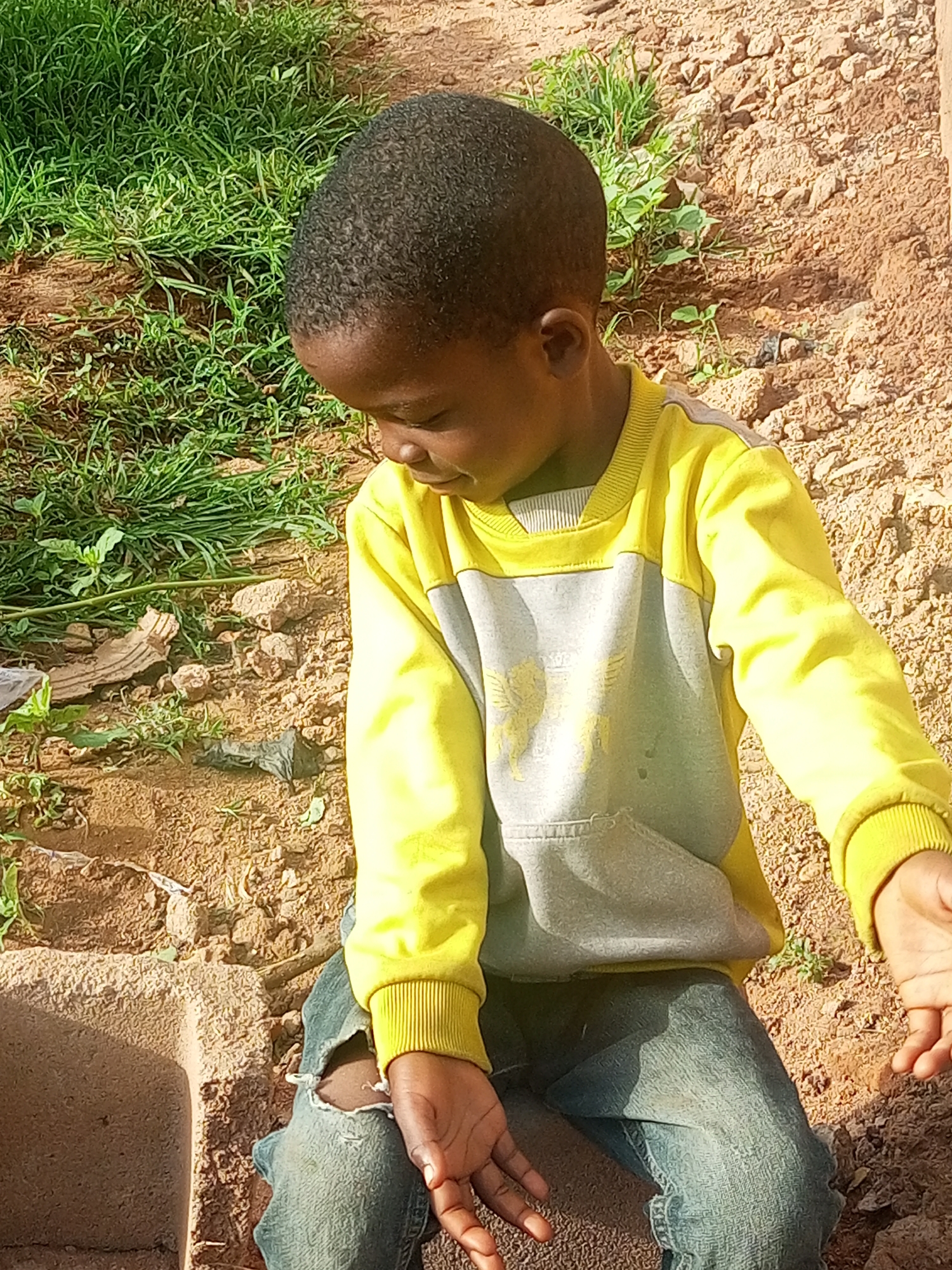 Kids and adults outdoors in casual moments near weathered walls