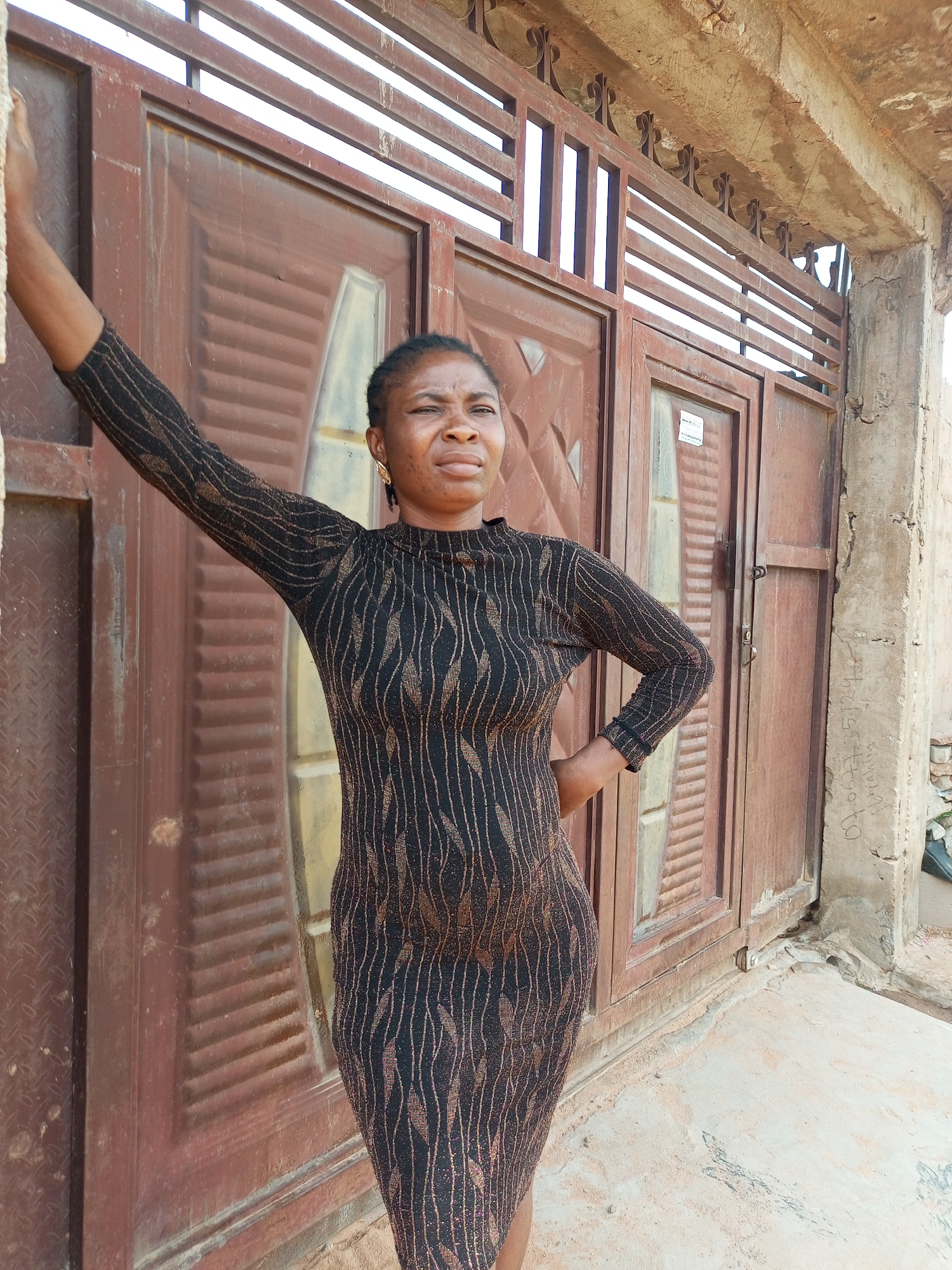 Casual portraits near a gate and wall in Tempure, Nigeria