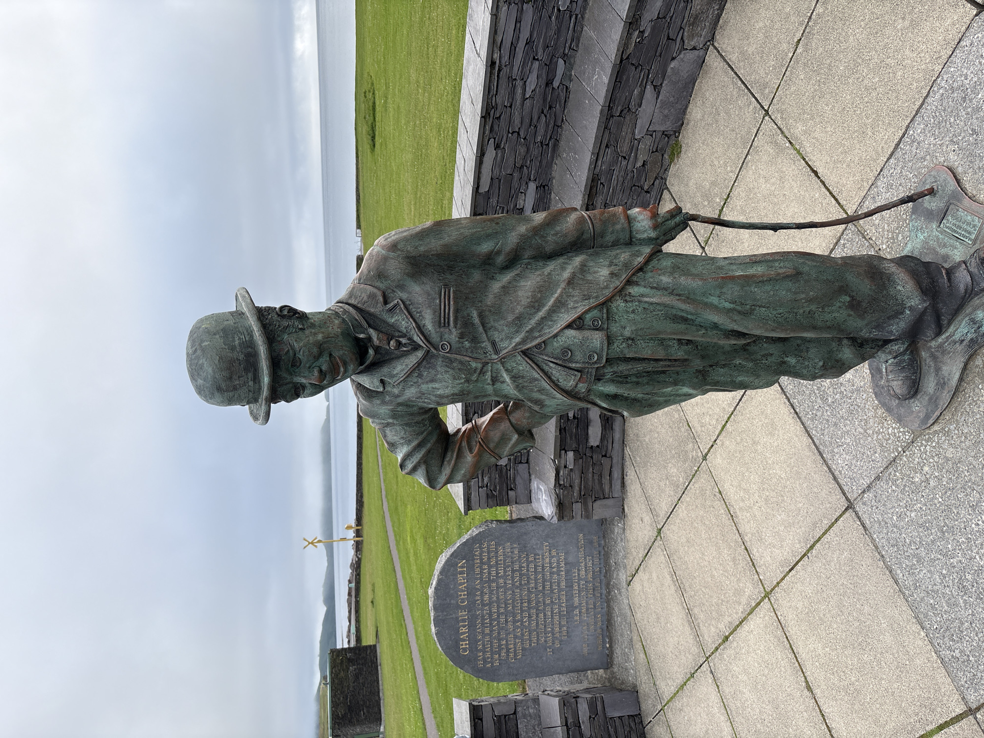Charlie Chaplin bronze statue overlooking Waterville's coastal landscape