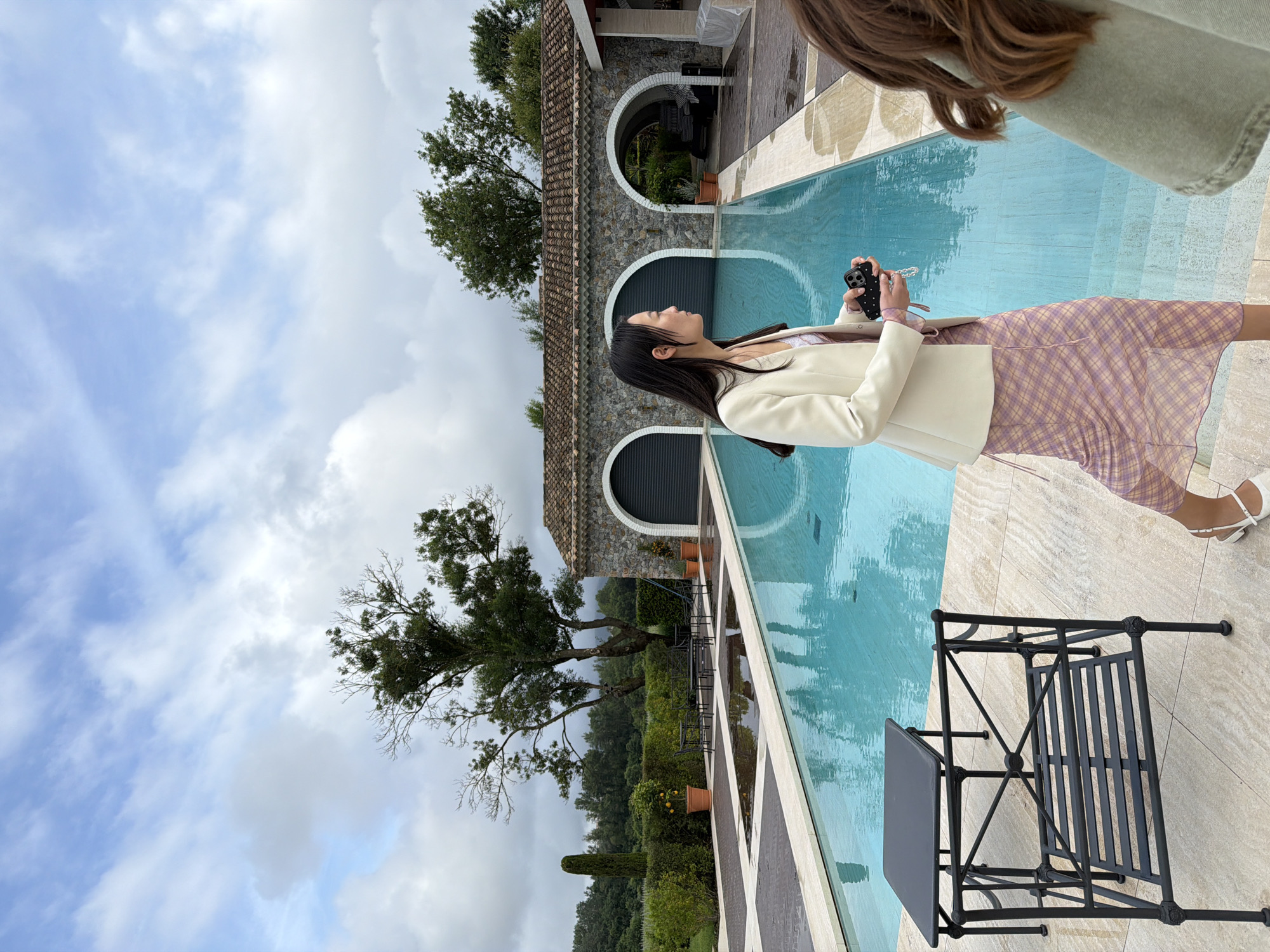 Woman photographed at manicured pool area in Cogolin, France