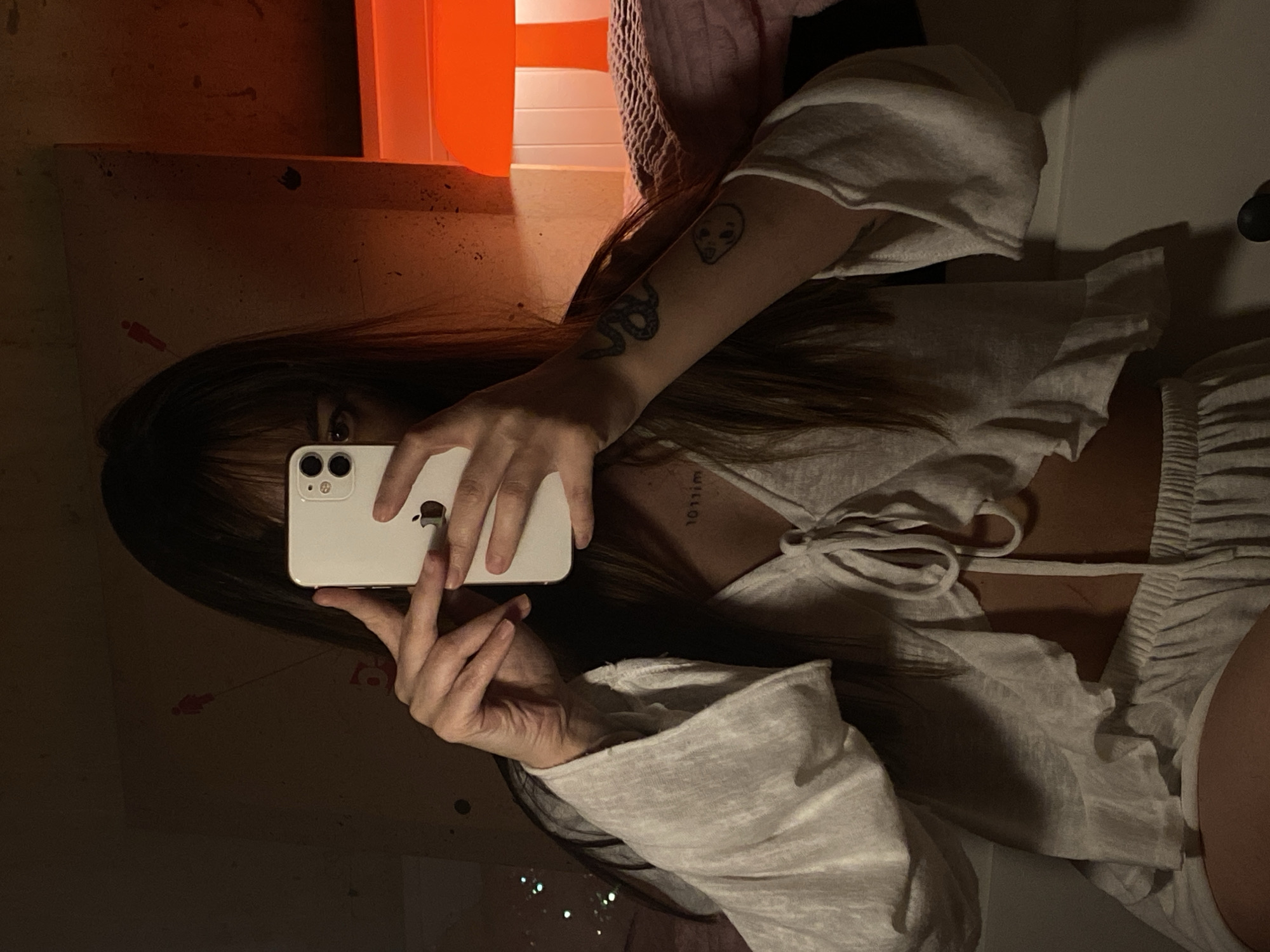 Person takes mirror selfie in cluttered room, Votkinsk