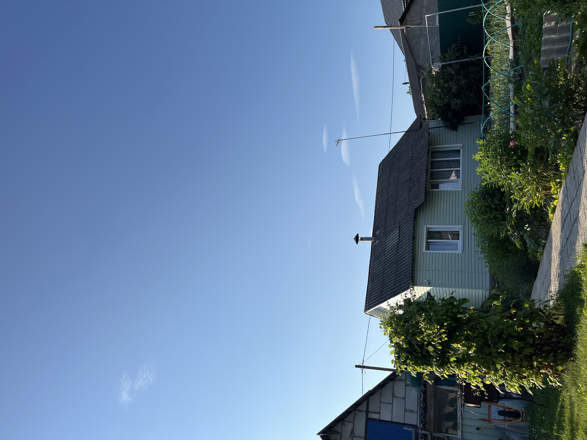 Backyard summer afternoon with pool, gazebo, and blue skies