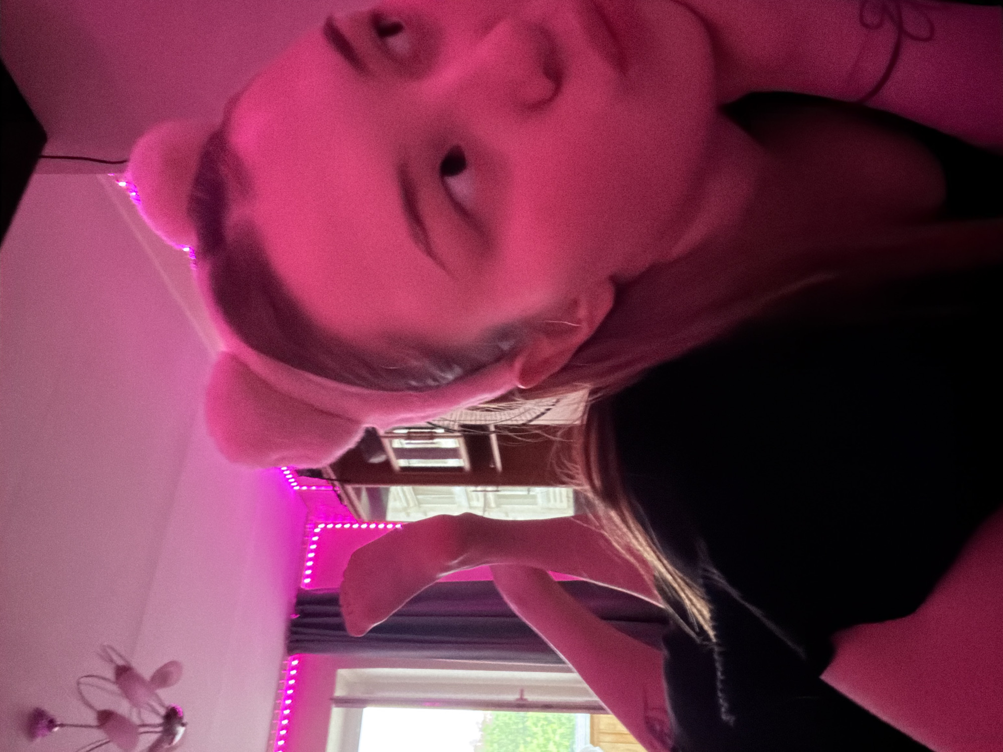 Indoor portraits and cat photos captured in pink-lit room
