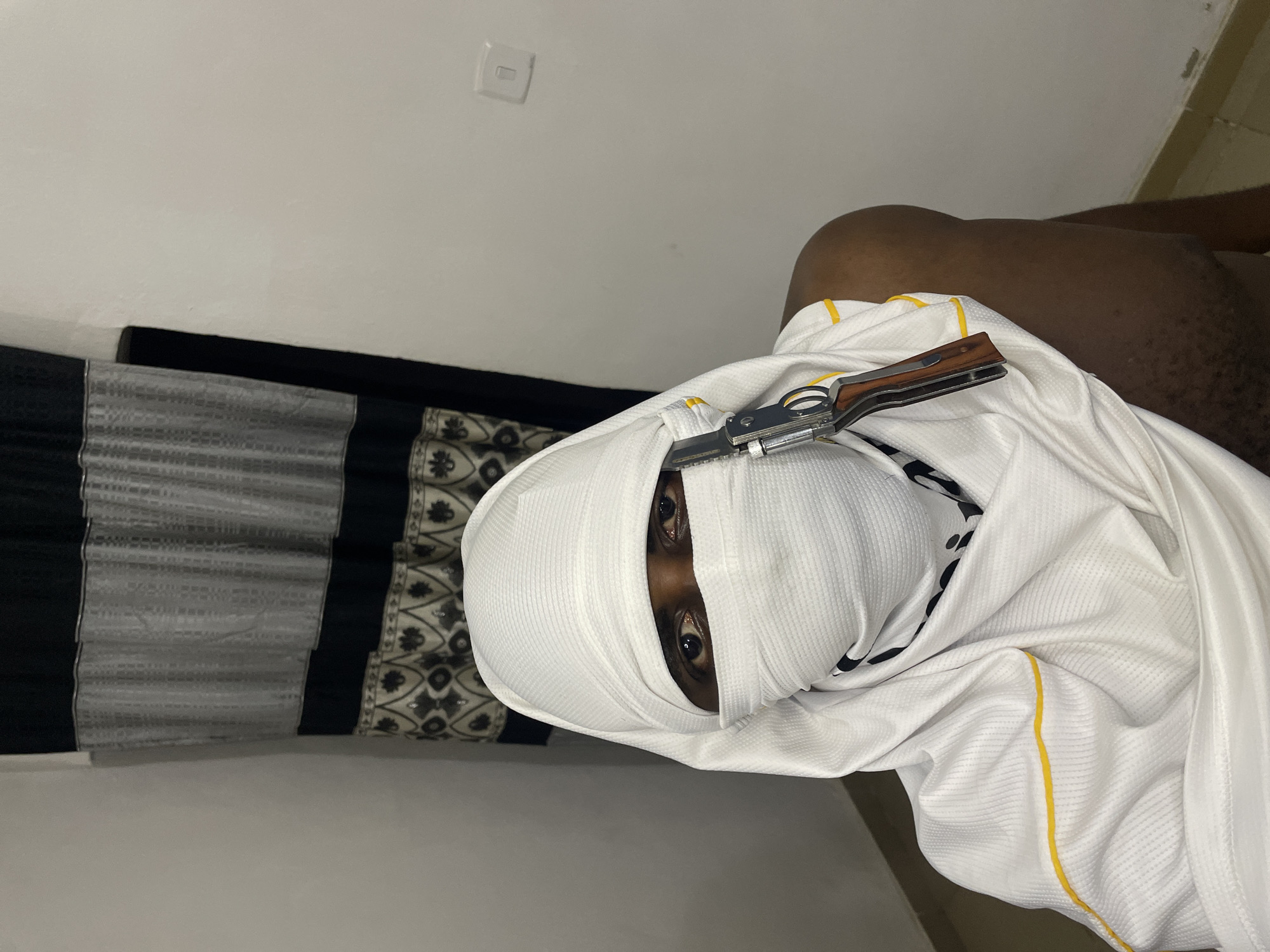 Masked individual photographed with knife in Akwanga residence